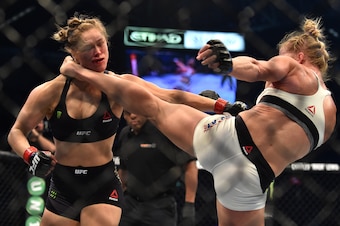 Holly Holm of the US (R) lands a kick to the neck to knock out compatriot Ronda Rousey and win the UFC title fight in Melbourne on November 15, 2015.   RESTRICTED TO EDITORIAL USE NO ADVERTISING USE NO PROMOTIONAL USE NO MERCHANDISING USE.   / AFP / PAUL 