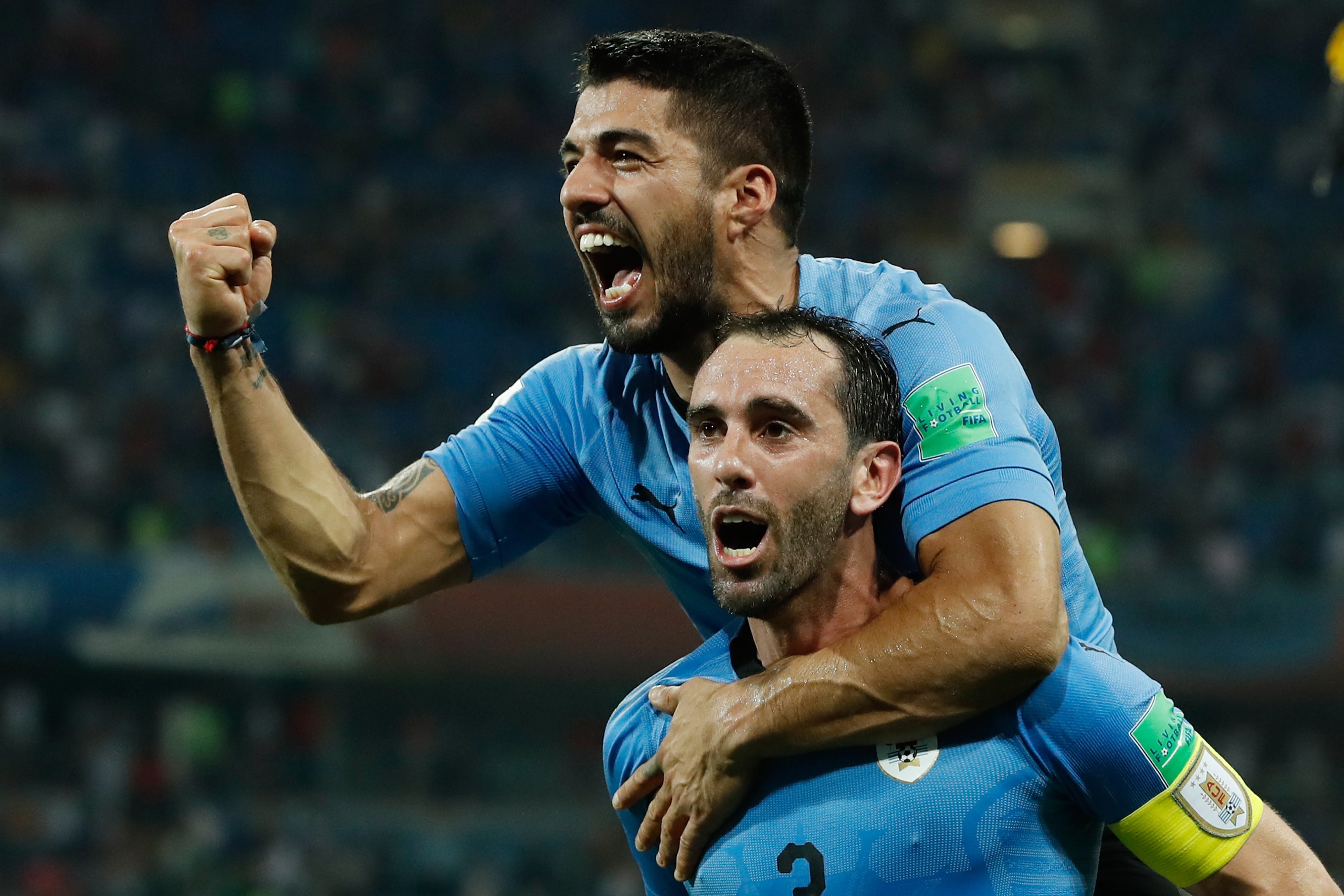 TOPSHOT - Uruguay's forward Luis Suarez and Uruguay's defender Diego Godin celebrate their win during the Russia 2018 World Cup round of 16 football match between Uruguay and Portugal at the Fisht Stadium in Sochi on June 30, 2018. - Uruguay sent Cristian