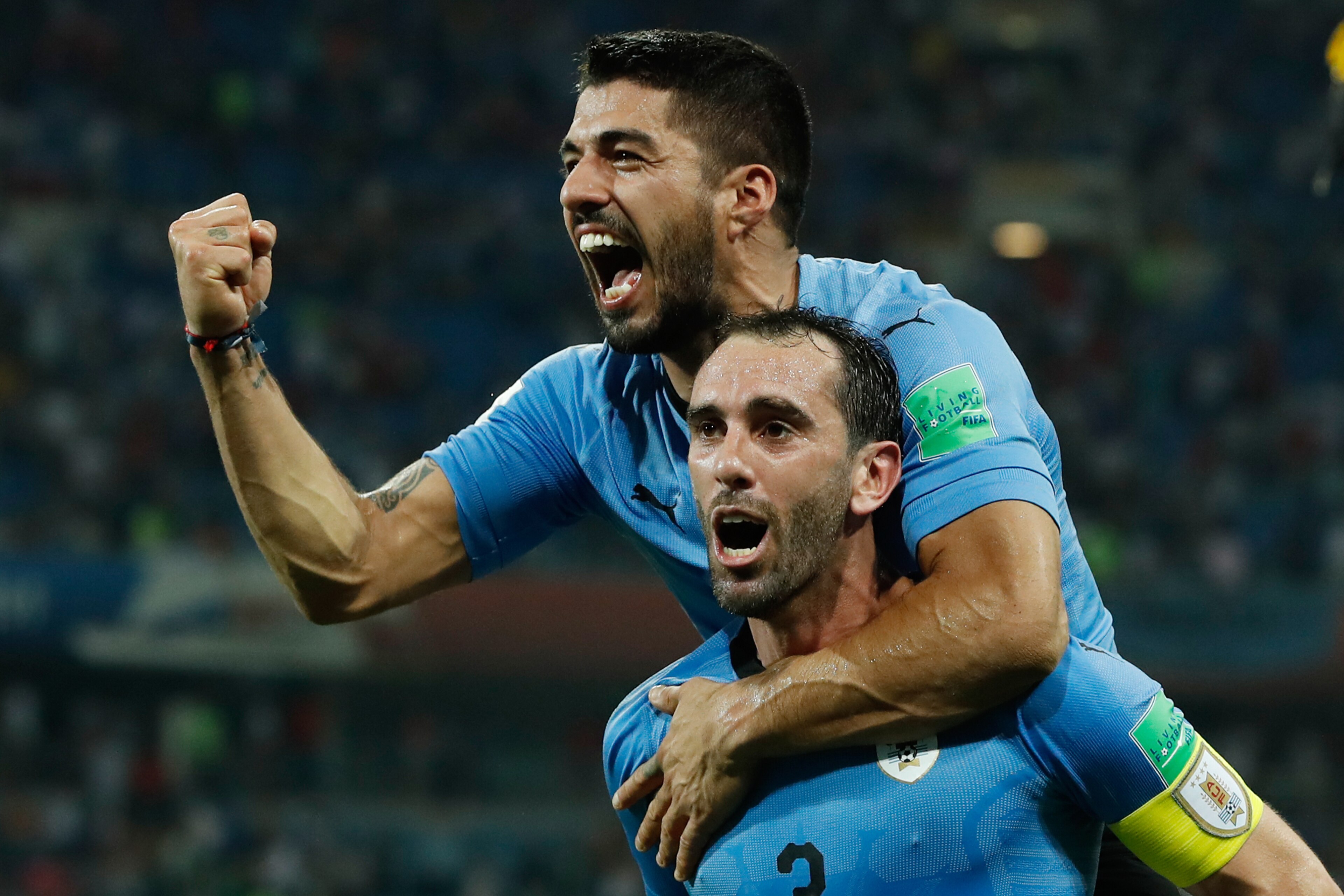TOPSHOT - Uruguay's forward Luis Suarez and Uruguay's defender Diego Godin celebrate their win during the Russia 2018 World Cup round of 16 football match between Uruguay and Portugal at the Fisht Stadium in Sochi on June 30, 2018. - Uruguay sent Cristian