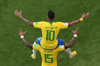 TOPSHOT - Brazil's forward Neymar celebrates scoring the opening goal on shoulders of Brazil's midfielder Paulinho during the Russia 2018 World Cup round of 16 football match between Brazil and Mexico at the Samara Arena in Samara on July 2, 2018. (Photo 