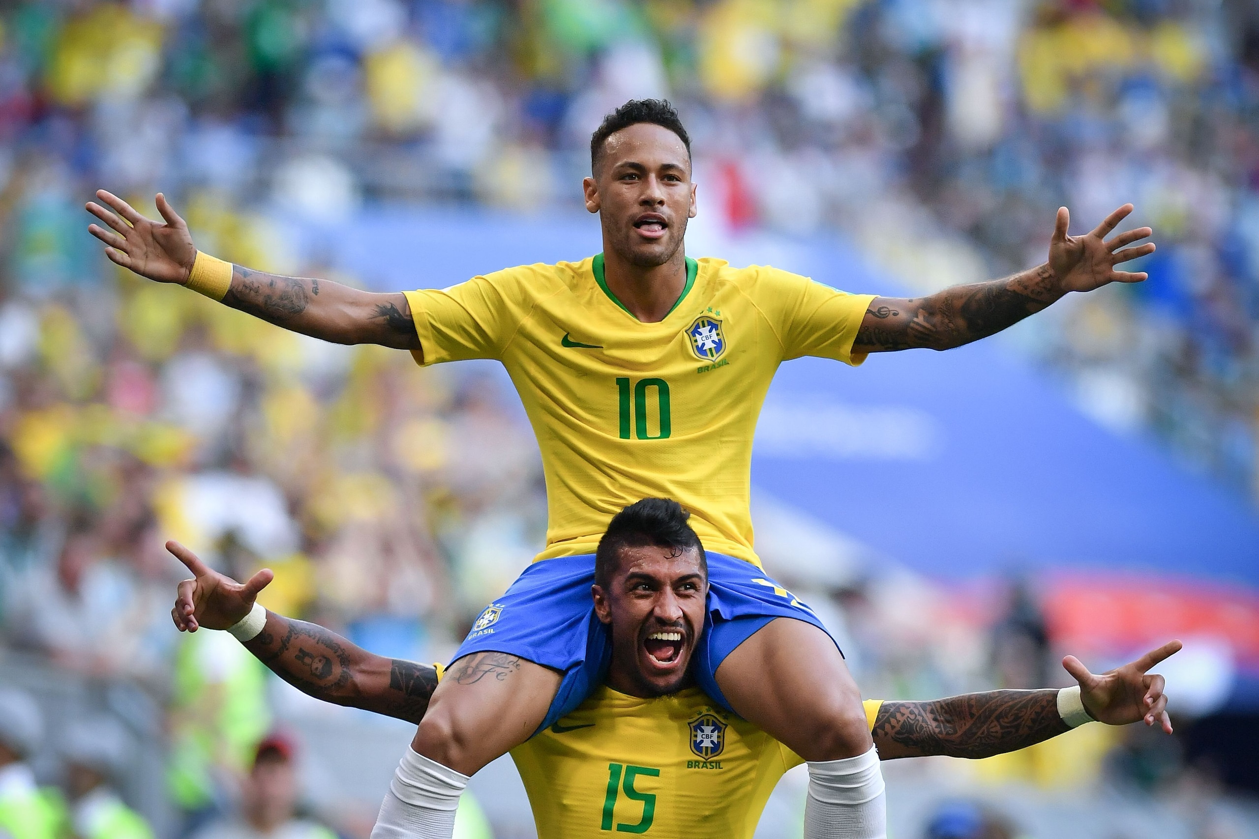 TOPSHOT - Brazil's forward Neymar celebrates with Brazil's midfielder Paulinho after scoring the opening goal during the Russia 2018 World Cup round of 16 football match between Brazil and Mexico at the Samara Arena in Samara on July 2, 2018. (Photo by Fa