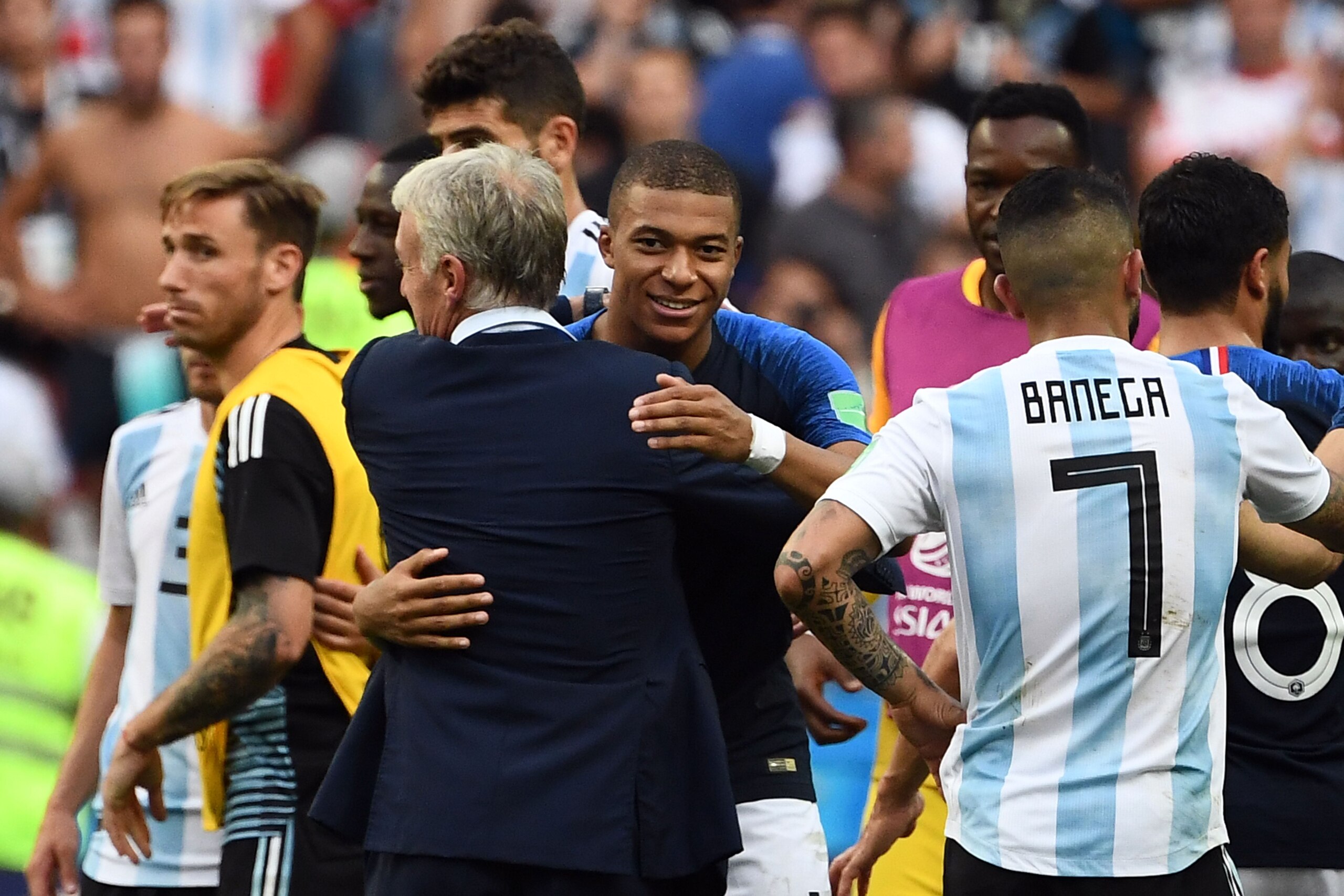 France's forward Kylian Mbappe (C) is congratulated by France's coach Didier Deschamps as they celebrate France's victory at the end of the Russia 2018 World Cup round of 16 football match between France and Argentina at the Kazan Arena in Kazan on June 3 France's forward Kylian Mbappe (C) is congratulated by France's coach Didier Deschamps as they celebrate France's victory at the end of the Russia 2018 World Cup round of 16 football match between France and Argentina at the Kazan Arena in Kazan on June 3