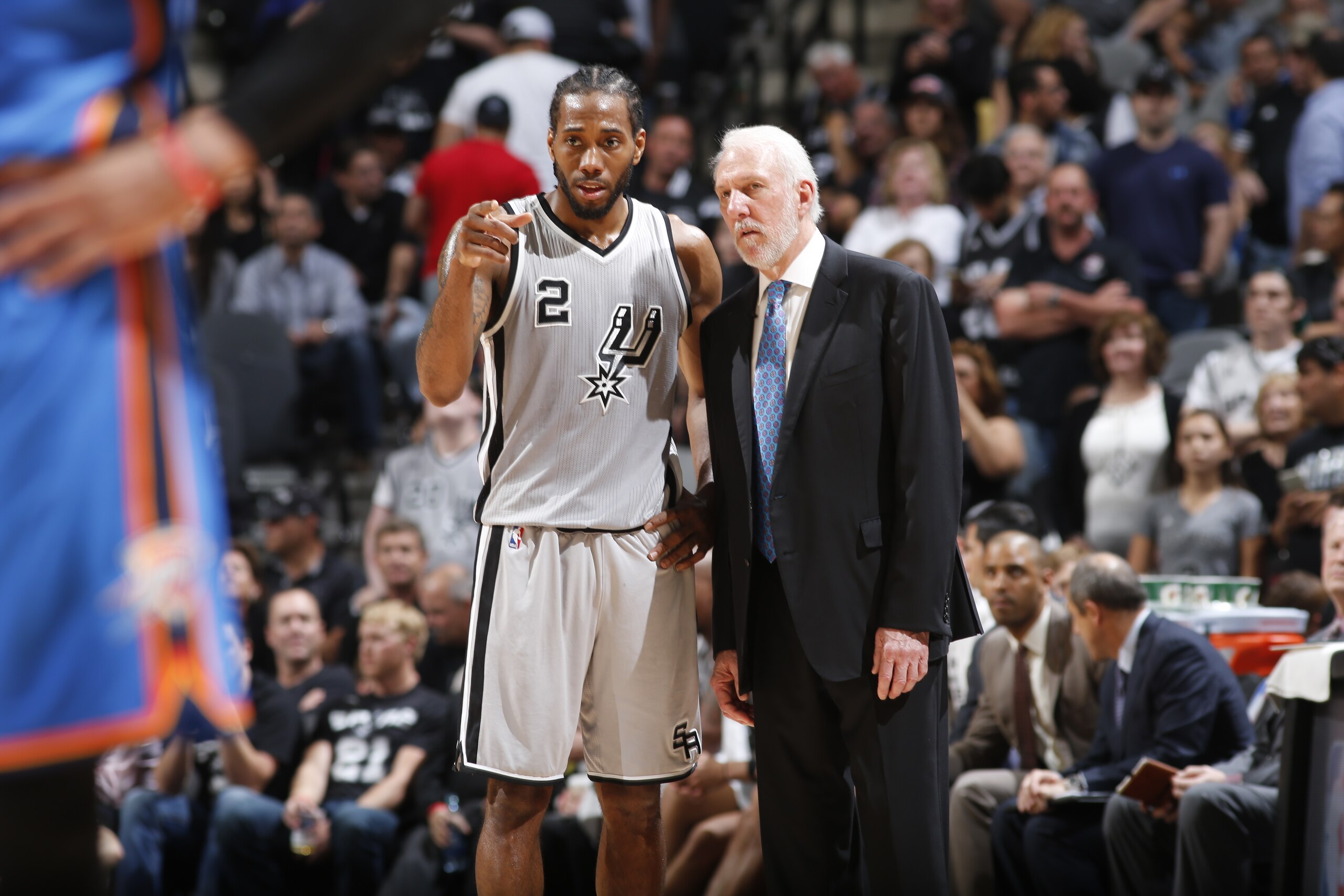 SAN ANTONIO, TX  - MARCH 12: Kawhi Leonard #2 speaks with head coach, Gregg Popovich of the San Antonio Spurs during the game against the Oklahoma City Thunder on March 12, 2016 at AT&T in San Antonio, Texas. NOTE TO USER: User expressly acknowledges and 