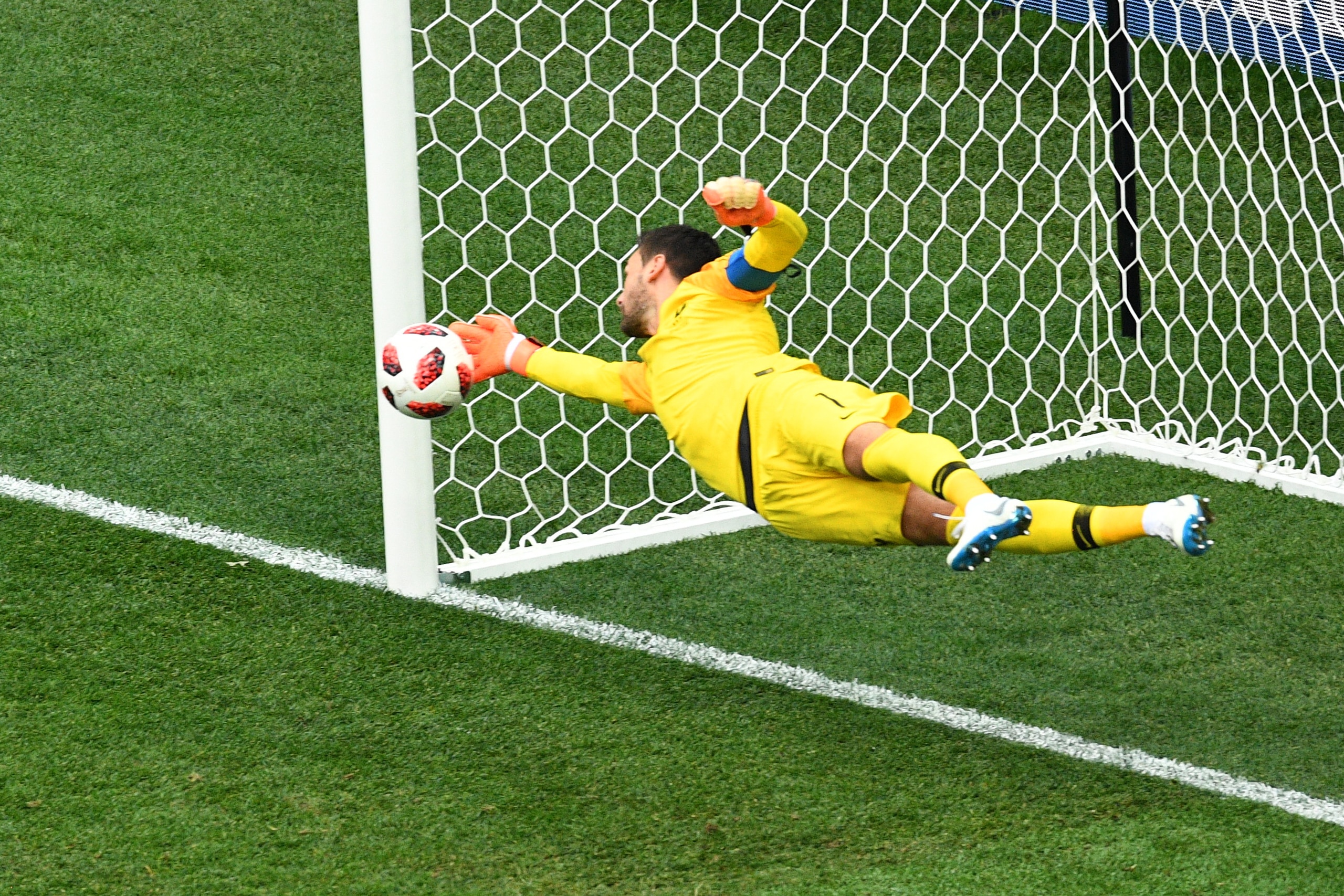 France's goalkeeper Hugo Lloris dives to make a save during the Russia 2018 World Cup quarter-final football match between Uruguay and France at the Nizhny Novgorod Stadium in Nizhny Novgorod on July 6, 2018. (Photo by Johannes EISELE / AFP)        (Photo