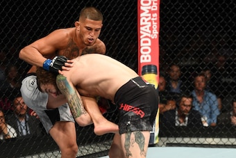 LAS VEGAS, NV - JULY 07: Michael Chiesa goes for a takedown against Anthony Pettis in their lightweight fight during the UFC 226 event inside T-Mobile Arena on July 7, 2018 in Las Vegas, Nevada.  (Photo by Josh Hedges/Zuffa LLC/Zuffa LLC via Getty Images)
