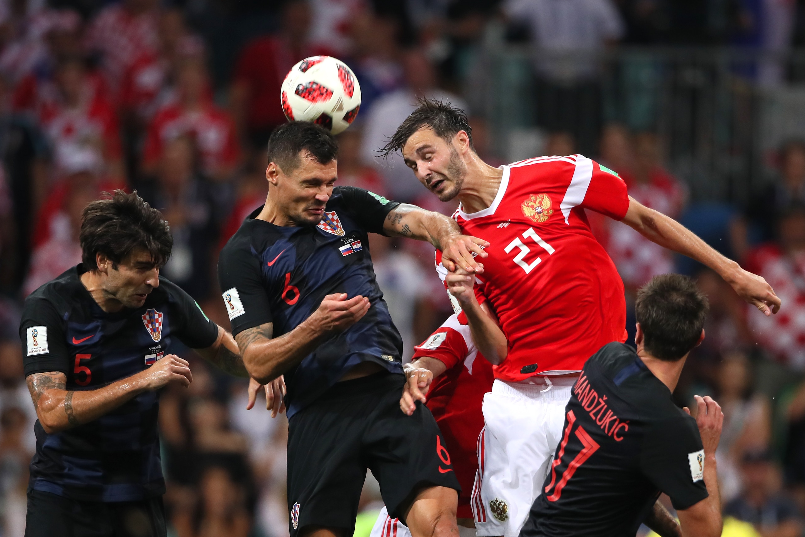 SOCHI, RUSSIA - JULY 07:   Dejan Lovren of Croatia competes with Aleksandr Erokhin of Russia during the 2018 FIFA World Cup Russia Quarter Final match between Russia and Croatia at Fisht Stadium on July 7, 2018 in Sochi, Russia. (Photo by Matthew Ashton -