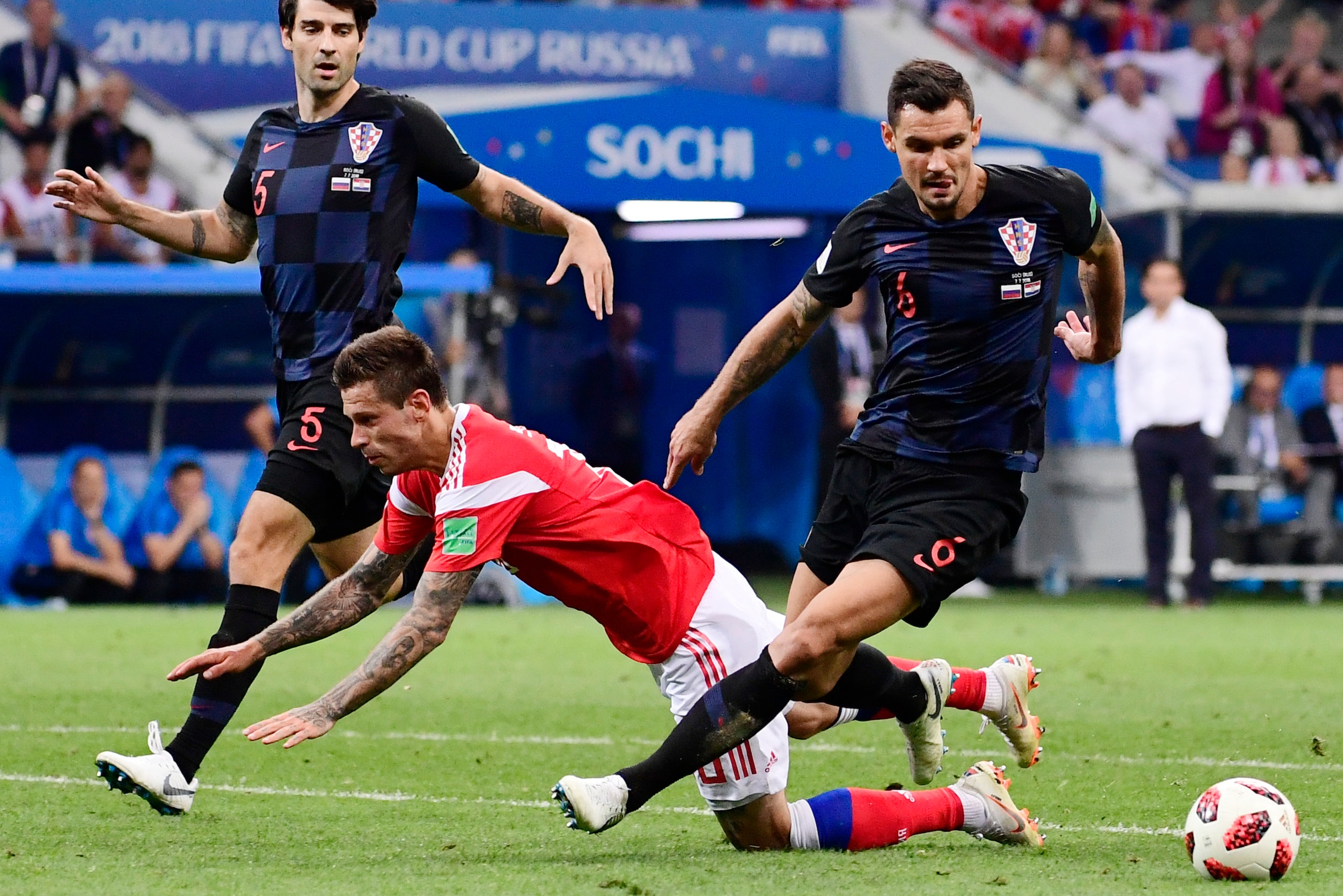 Russia's forward Fedor Smolov (C) challenges Croatia's defender Dejan Lovren (R) and Croatia's defender Vedran Corluka during the Russia 2018 World Cup quarter-final football match between Russia and Croatia at the Fisht Stadium in Sochi on July 7, 2018. 