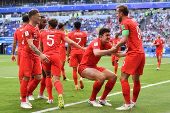 TOPSHOT - England's defender Harry Maguire (2ndR) celebrates with England's forward Harry Kane after scoring the opener during the Russia 2018 World Cup quarter-final football match between Sweden and England at the Samara Arena in Samara on July 7, 2018.