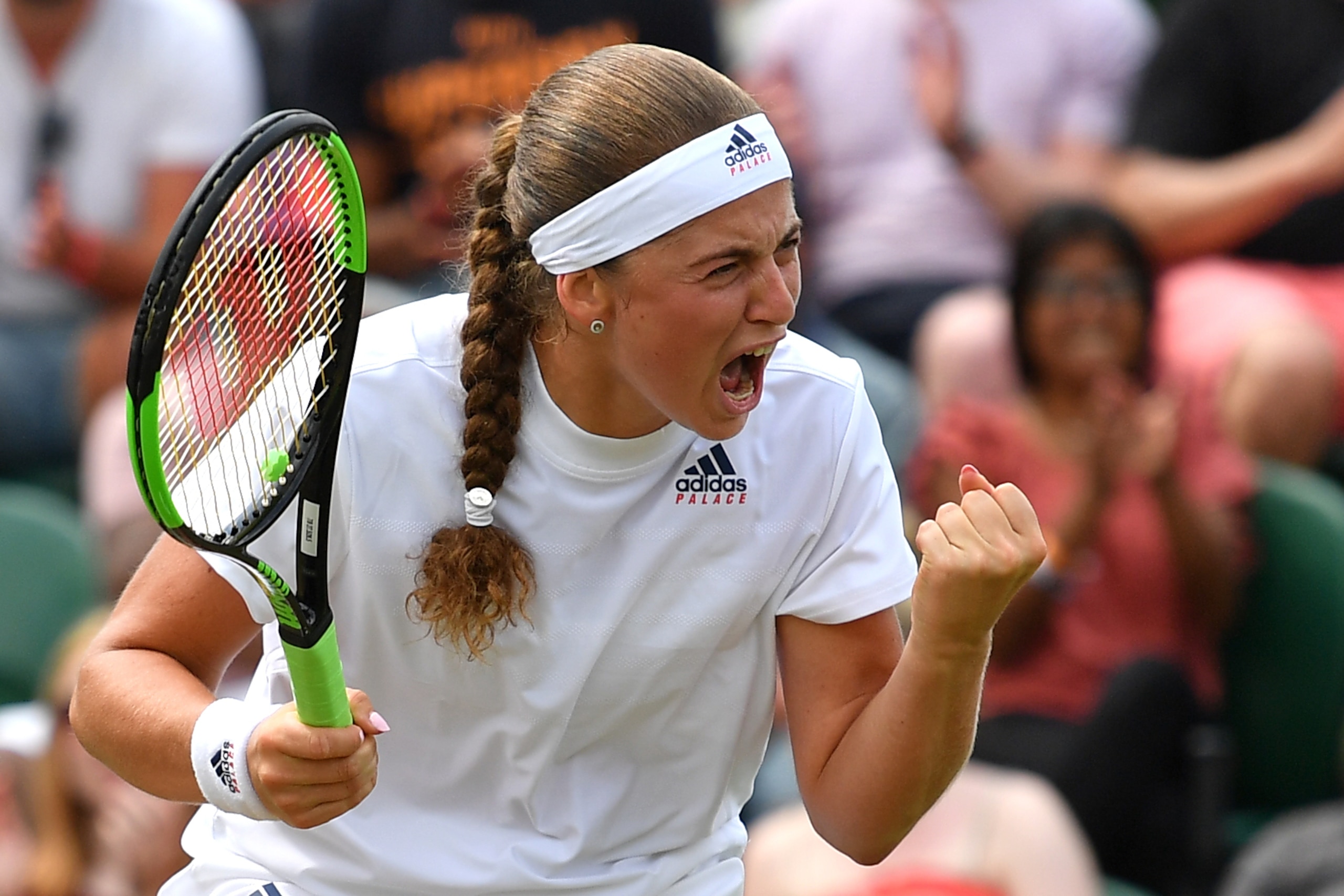TOPSHOT - Latvia's Jelena Ostapenko celebrates a point against Belarus' Aliaksandra Sasnovich in their women's singles fourth round match on the seventh day of the 2018 Wimbledon Championships at The All England Lawn Tennis Club in Wimbledon, southwest Lo