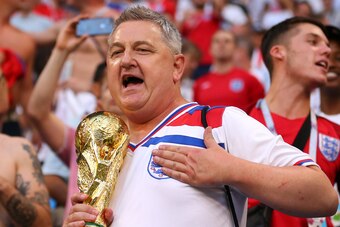 SAMARA, RUSSIA - JULY 07:    An England fan holds a replica of the world cup trophy at the end of the 2018 FIFA World Cup Russia Quarter Final match between Sweden and England at Samara Arena on July 7, 2018 in Samara, Russia. (Photo by Robbie Jay Barratt
