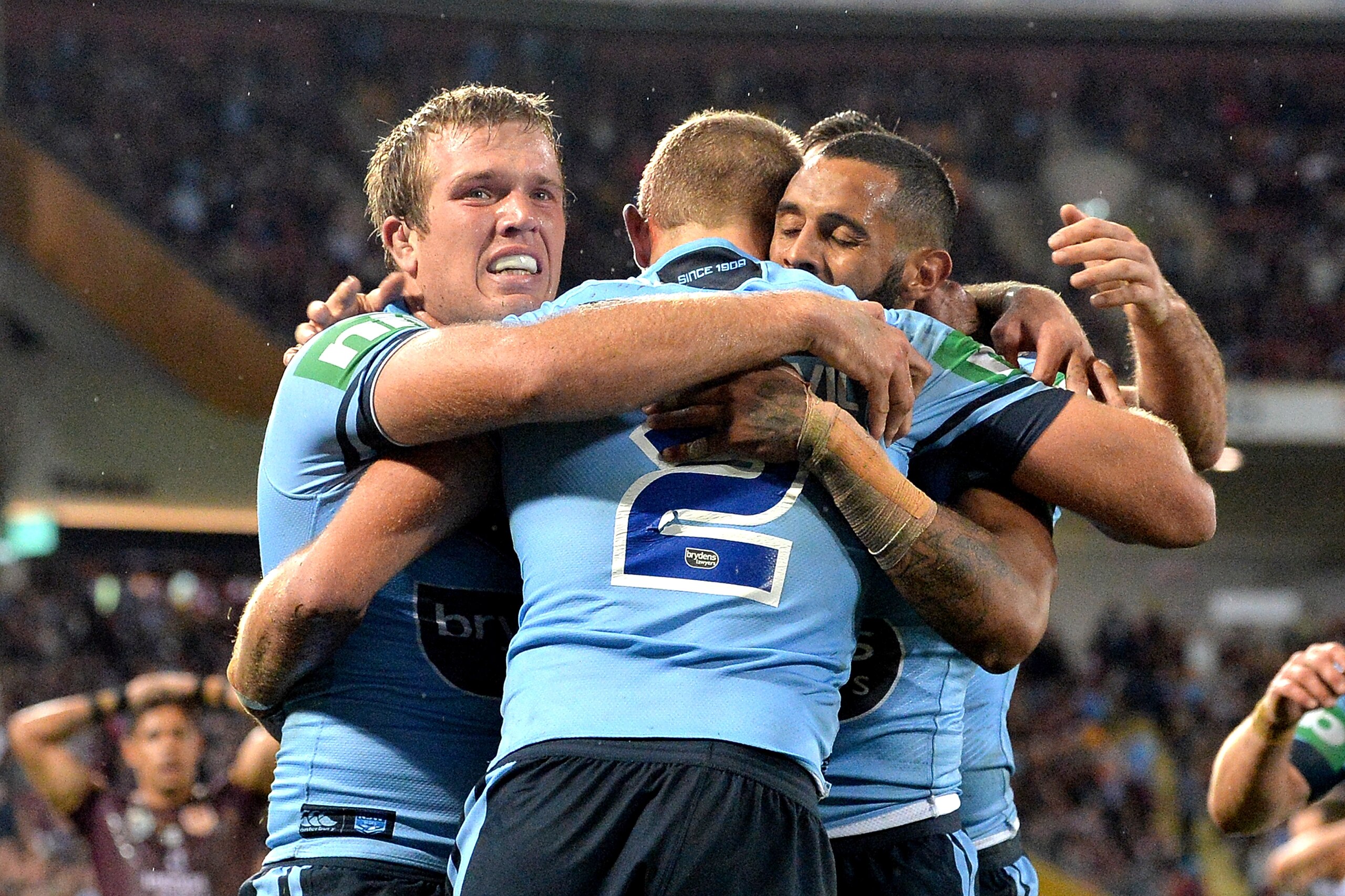BRISBANE, AUSTRALIA - JULY 11: Tom Trbojevic of the Blues is congratulated by team mates after scoring a try during game three of the State of Origin series between the Queensland Maroons and the New South Wales Blues at Suncorp Stadium on July 11, 2018 BRISBANE, AUSTRALIA - JULY 11: Tom Trbojevic of the Blues is congratulated by team mates after scoring a try during game three of the State of Origin series between the Queensland Maroons and the New South Wales Blues at Suncorp Stadium on July 11, 2018