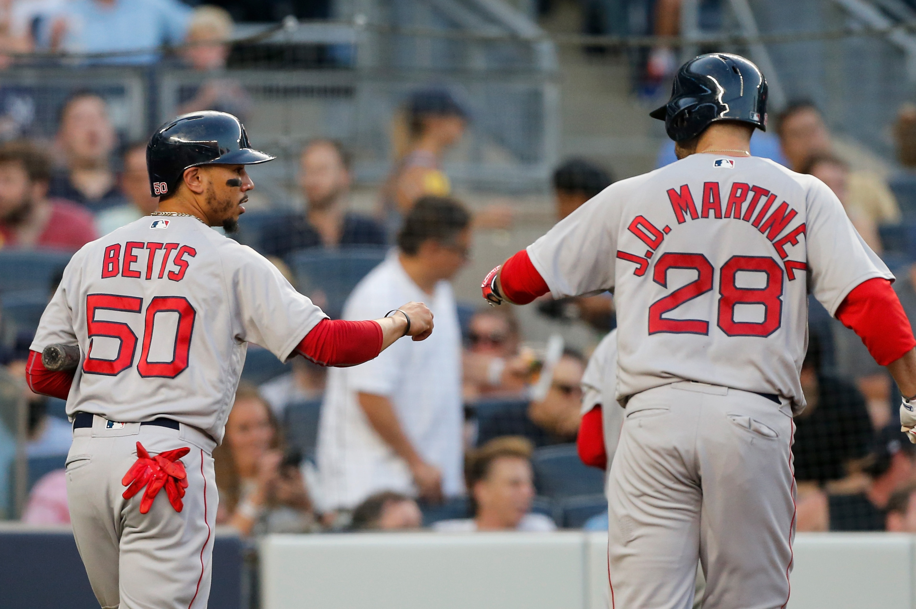 NEW YORK, NY - JUNE 30:  Mookie Betts #50 and J.D. Martinez #28 of the Boston Red Sox in action against the New York Yankees at Yankee Stadium on June 30, 2018 in the Bronx borough of New York City. The Red Sox defeated the Yankees 11-0.  (Photo by Jim Mc