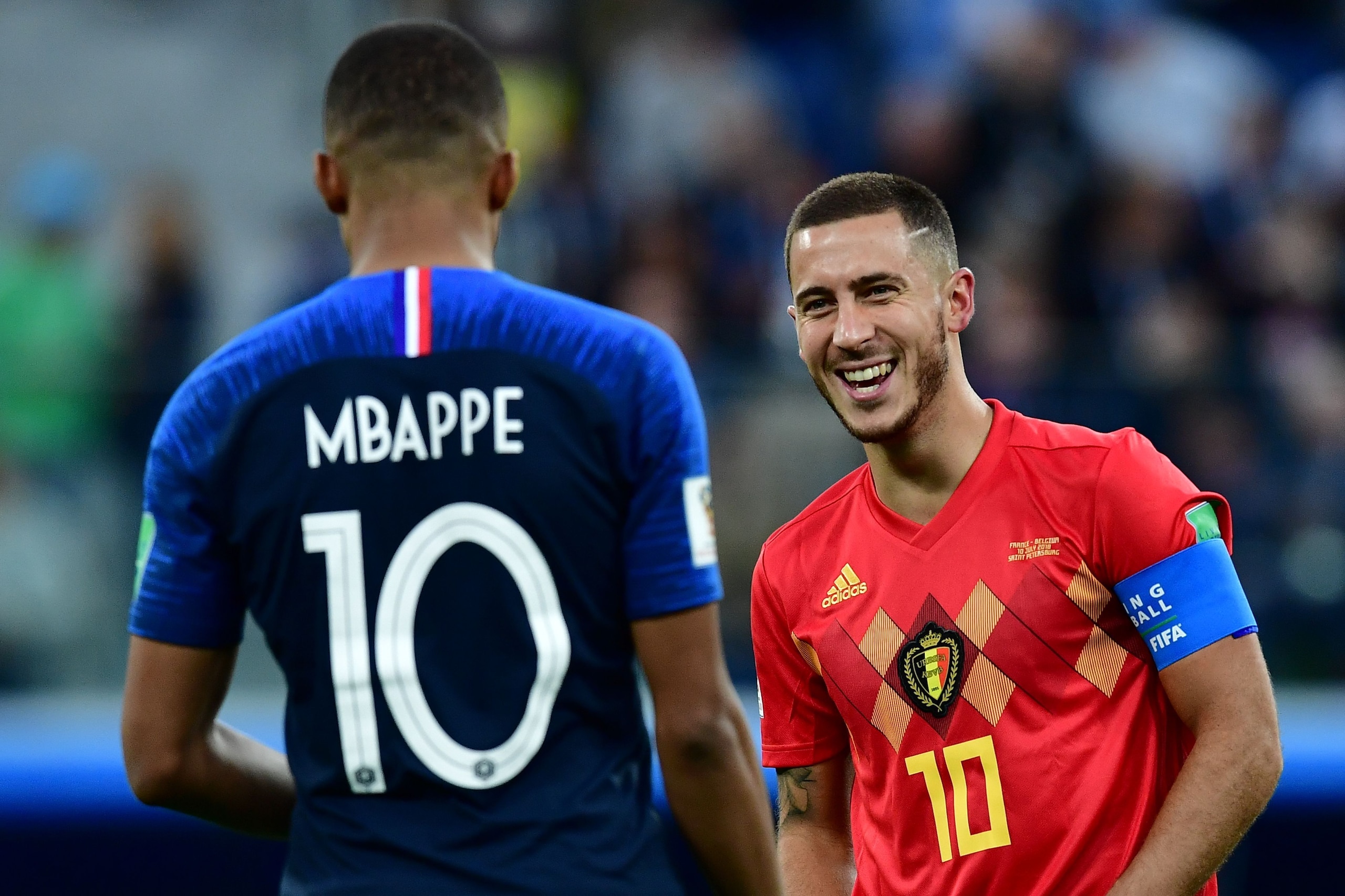 France's forward Kylian Mbappe (L) speaks with Belgium's forward Eden Hazard during the Russia 2018 World Cup semi-final football match between France and Belgium at the Saint Petersburg Stadium in Saint Petersburg on July 10, 2018. (Photo by Giuseppe CAC