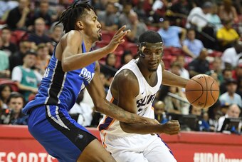 LAS VEGAS, NV - JULY 09:  Josh Jackson #20 of the Phoenix Suns drives against Braian Angola-Rodas #19 of the Orlando Magic during the 2018 NBA Summer League at the Thomas & Mack Center on July 9, 2018 in Las Vegas, Nevada. The Suns defeated the Magic 71-5