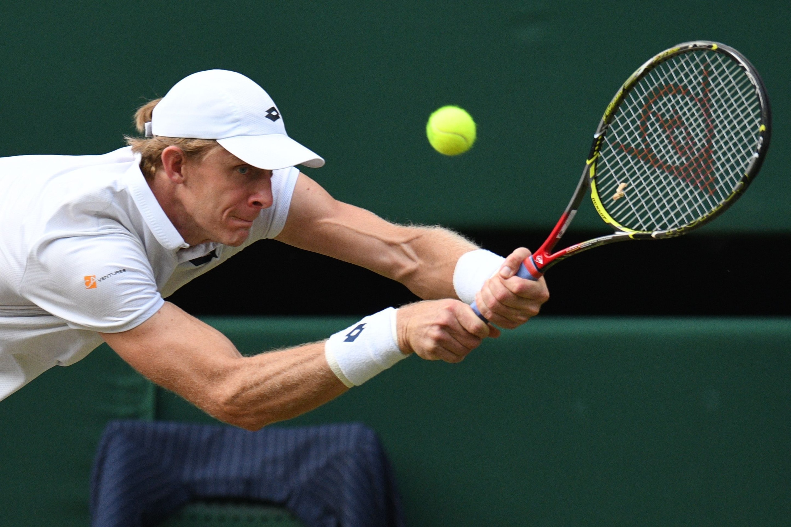 TOPSHOT - South Africa's Kevin Anderson returns against US player John Isner during their men's singles semi-final match on the eleventh day of the 2018 Wimbledon Championships at The All England Lawn Tennis Club in Wimbledon, southwest London, on July 13