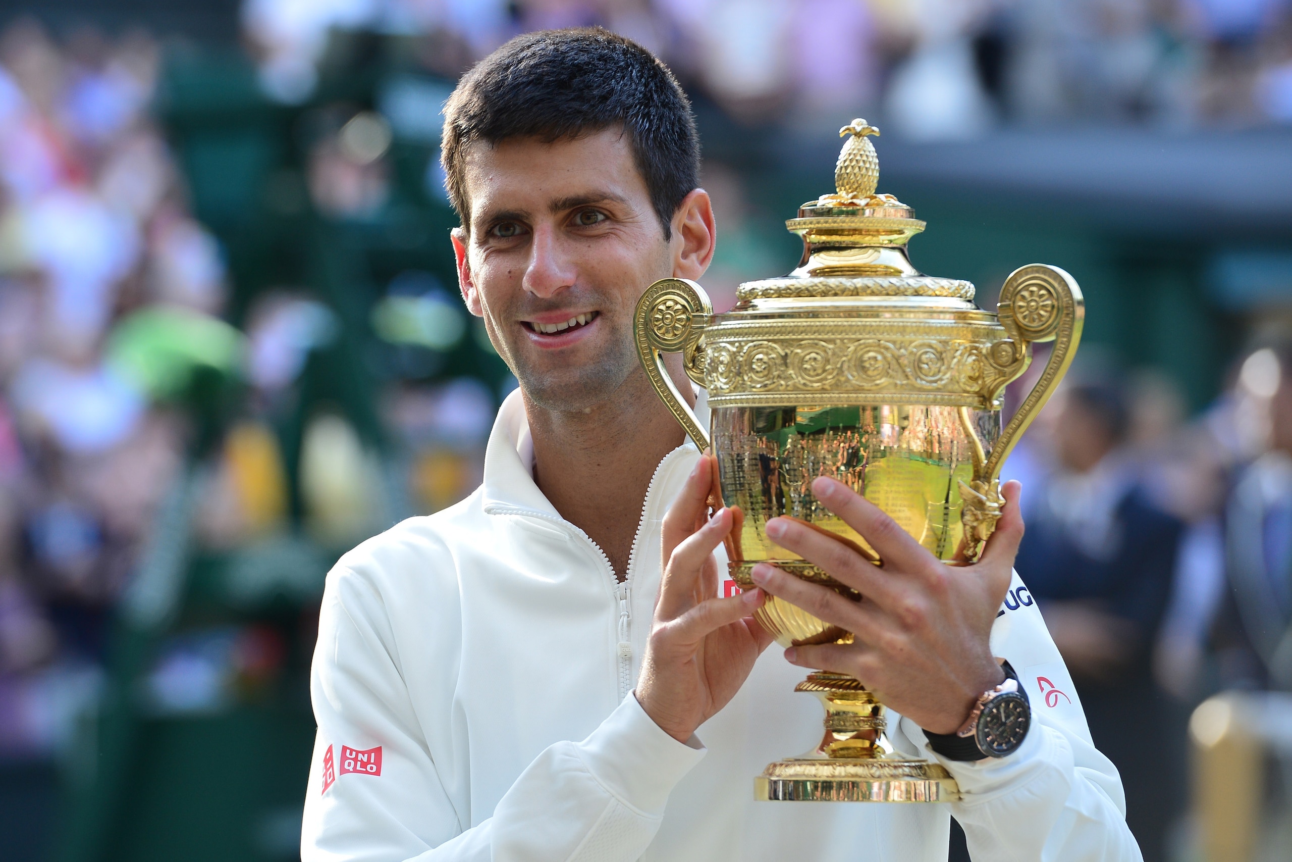 Serbia's Novak Djokovic holds the winner's trophy after beating Switzerland's Roger Federer in the men's singles final match during the presentation on day thirteen of  the 2014 Wimbledon Championships at The All England Tennis Club in Wimbledon, southwes