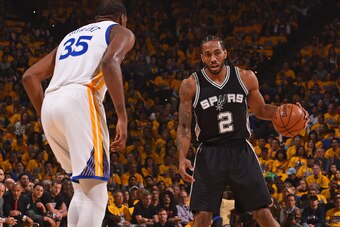 OAKLAND, CA - MAY 14:  Kawhi Leonard #2 of the San Antonio Spurs dribbles the ball while guarded by Kevin Durant #35 of the Golden State Warriors in Game One of the Western Conference Finals during the 2017 NBA Playoffs on May 14, 2017 at ORACLE Arena in 