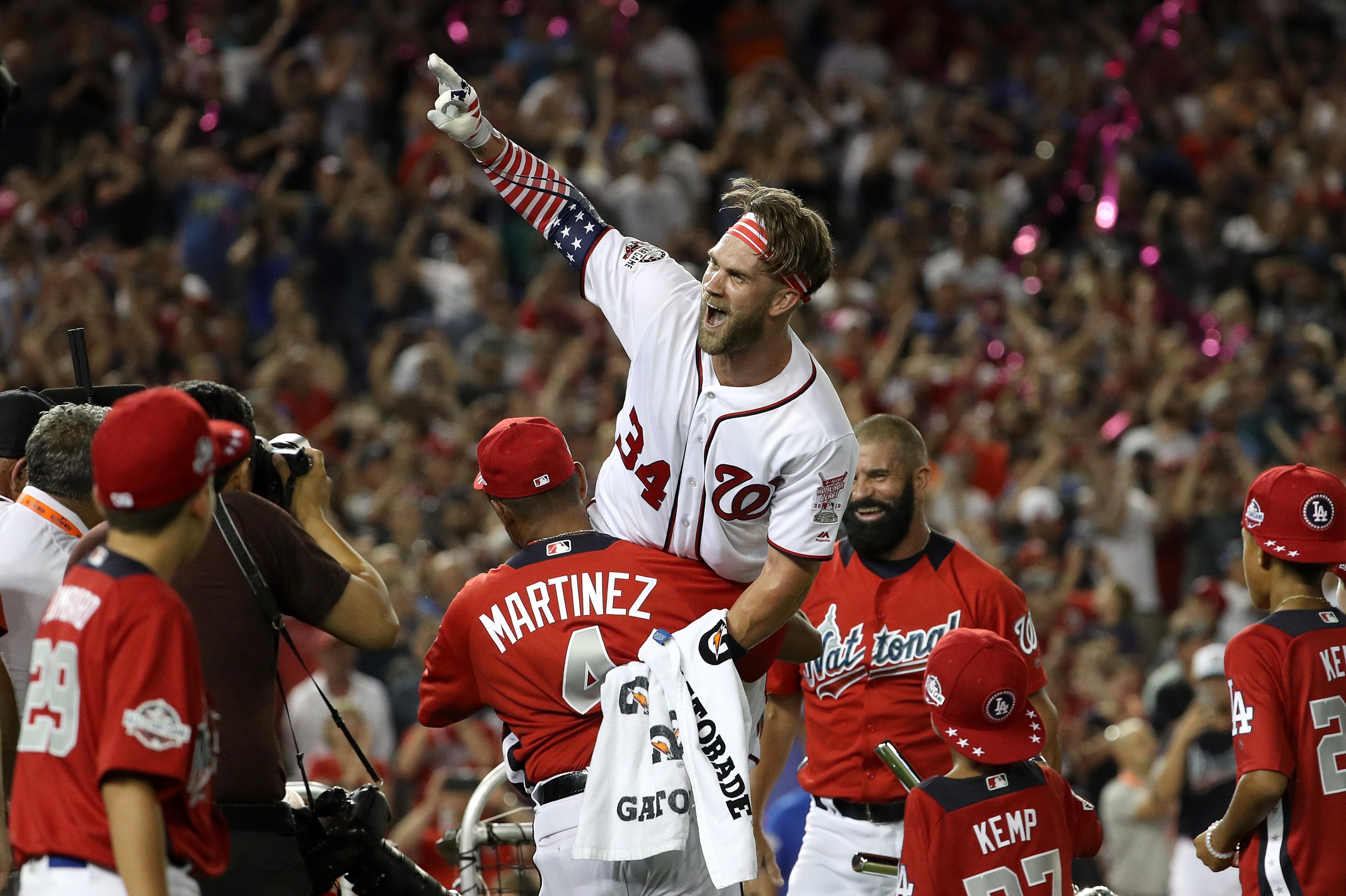 WASHINGTON, DC - JULY 16:  Bryce Harper of the Washington Nationals and National League celebrates with his manager Dave Martinez and father Ron Harper after winning the T-Mobile Home Run Derby at Nationals Park on July 16, 2018 in Washington, DC. Harper 