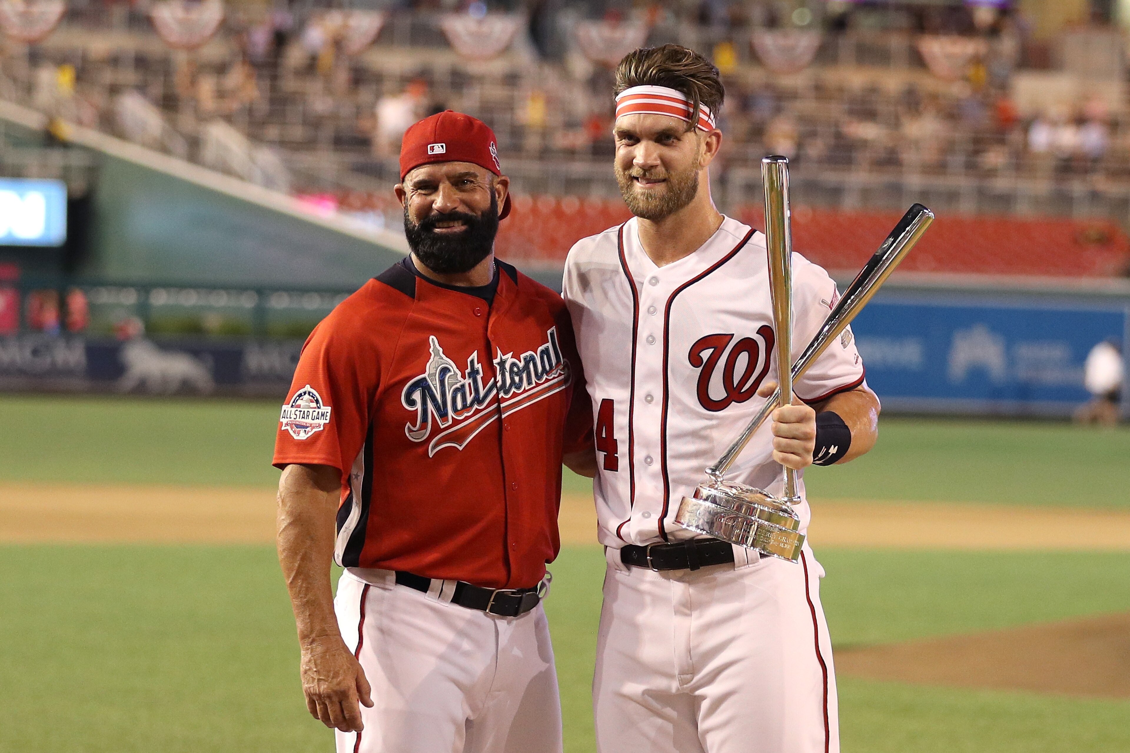 WASHINGTON, DC - JULY 16:  Bryce Harper of the Washington Nationals and National League celebrates with the trophy and father Ron Harper after winning the T-Mobile Home Run Derby at Nationals Park on July 16, 2018 in Washington, DC.  Harper defeated Kyle 