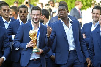 PARIS, FRANCE - JULY 16:  France Captain Hugo Lloris and Paul Pogba react as he holds the trophy  as French President Emmanuel Macron receives the France football team during a ceremony at the Elysee Palace on July 16, 2018 in Paris, France. France beat C