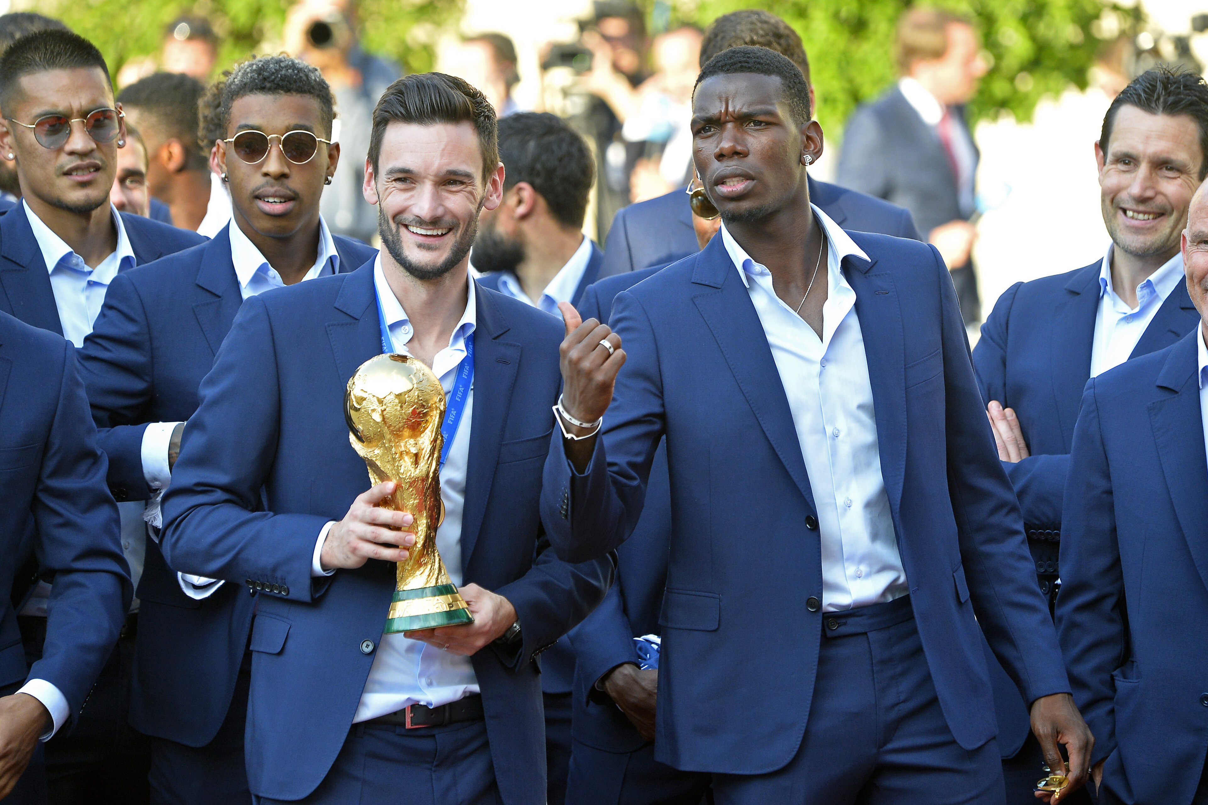 PARIS, FRANCE - JULY 16:  France Captain Hugo Lloris and Paul Pogba react as he holds the trophy  as French President Emmanuel Macron receives the France football team during a ceremony at the Elysee Palace on July 16, 2018 in Paris, France. France beat C