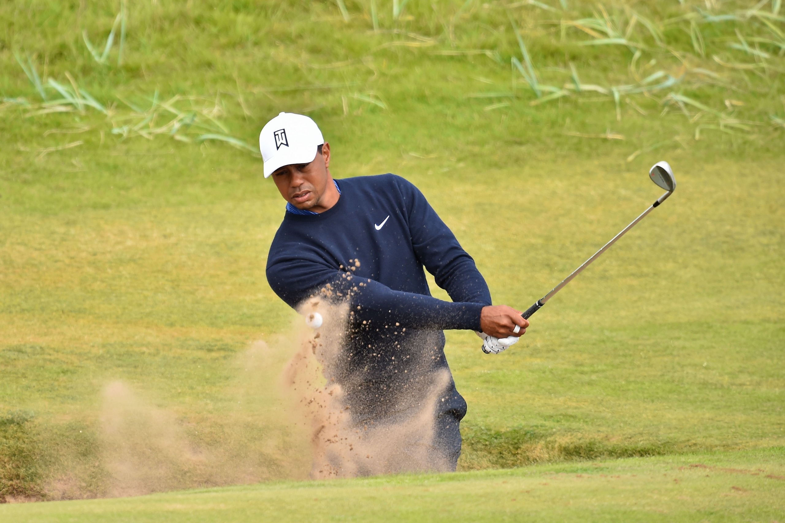 US golfer Tiger Woods plays out of a green-side bunker on the 6th hole during a practice round at The 147th Open golf Championship at Carnoustie, Scotland on July 17, 2018. (Photo by Glyn KIRK / AFP)        (Photo credit should read GLYN KIRK/AFP/Getty Im