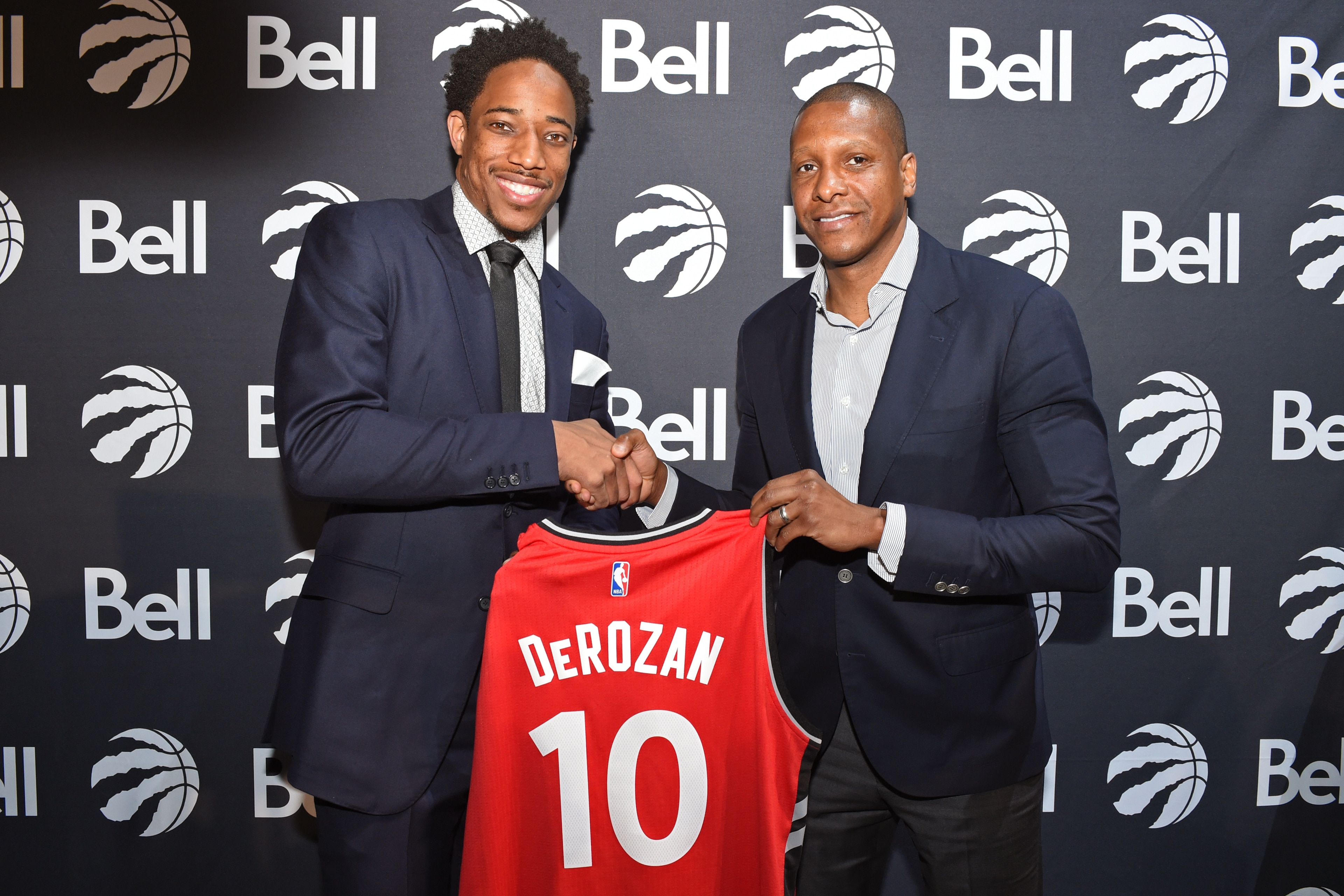 TORONTO, CANADA - JULY 14:  DeMar DeRozan #10 and Masai Ujiri of the Toronto Raptors pose for a photo during a press conference after announcing his new deal on July 14, 2016 at the Real Sports Bar & Grill in Toronto, Ontario, Canada.  NOTE TO USER: User 
