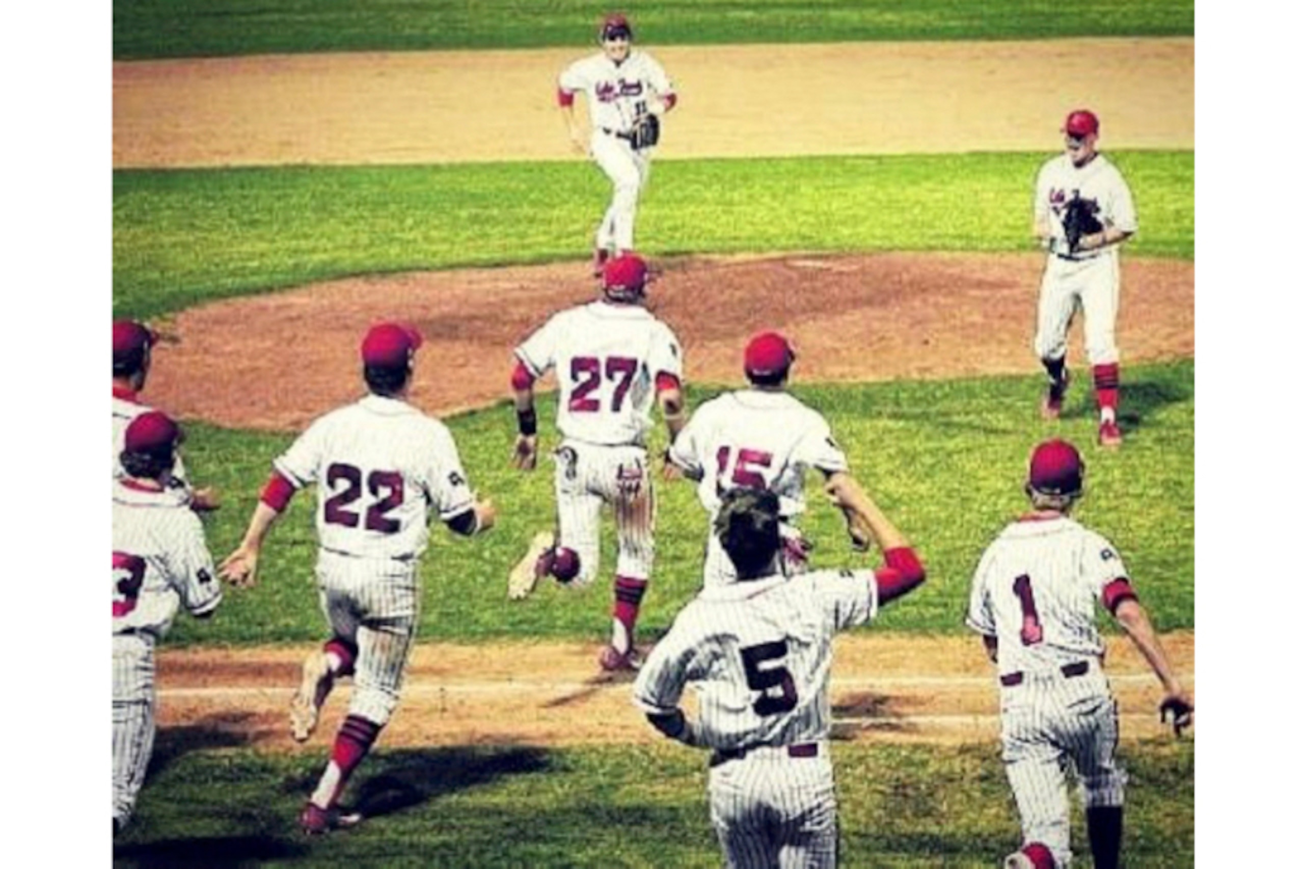 Mayfield (top) and teammates rush to celebrate with Mayes after his perfect game.