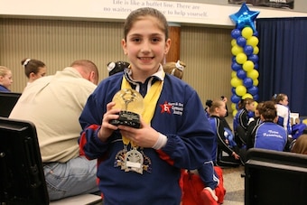 Brennan, 8, smiles after winning every event and all around at a level 4 event.