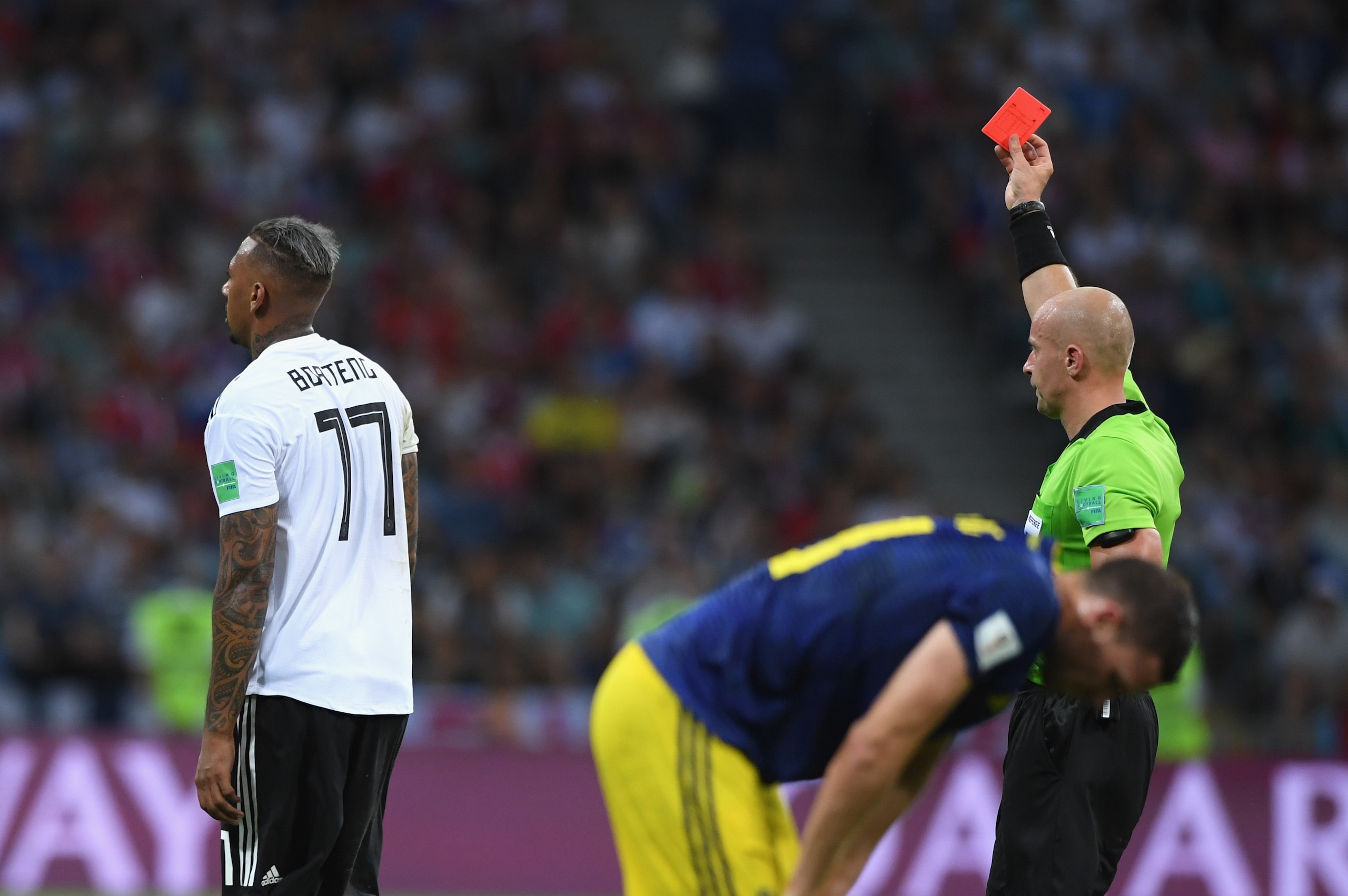SOCHI, RUSSIA - JUNE 23:  Referee Szymon Marciniak gives Germany player Jerome Boateng a red card during the 2018 FIFA World Cup Russia group F match between Germany and Sweden at Fisht Stadium on June 23, 2018 in Sochi, Russia.  (Photo by Stu Forster/Get