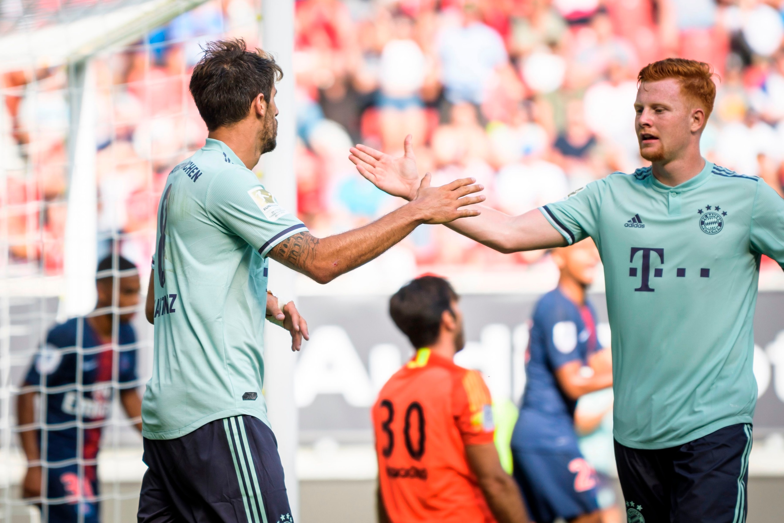Bayern Munich's Javier Martinez (L) and Paul Will (R) celebrate after scoring a goal during their International Champions Cup football match Bayern Munich against Paris Saint-Germain (PSG) on July 21, 2018 at the Worthersee Stadium in Klagenfurt, Austria.
