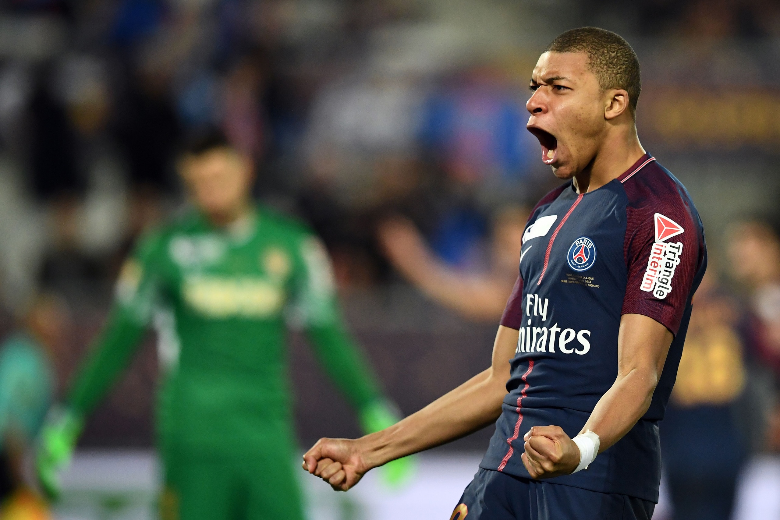 TOPSHOT - Paris Saint-Germain's French forward Kylian Mbappé celebrates after unseen teammate Uruguayan forward Edinson Cavani scored his team's third goal during the French League Cup final football match between Monaco (ASM) and Paris Saint-Germain (PSG