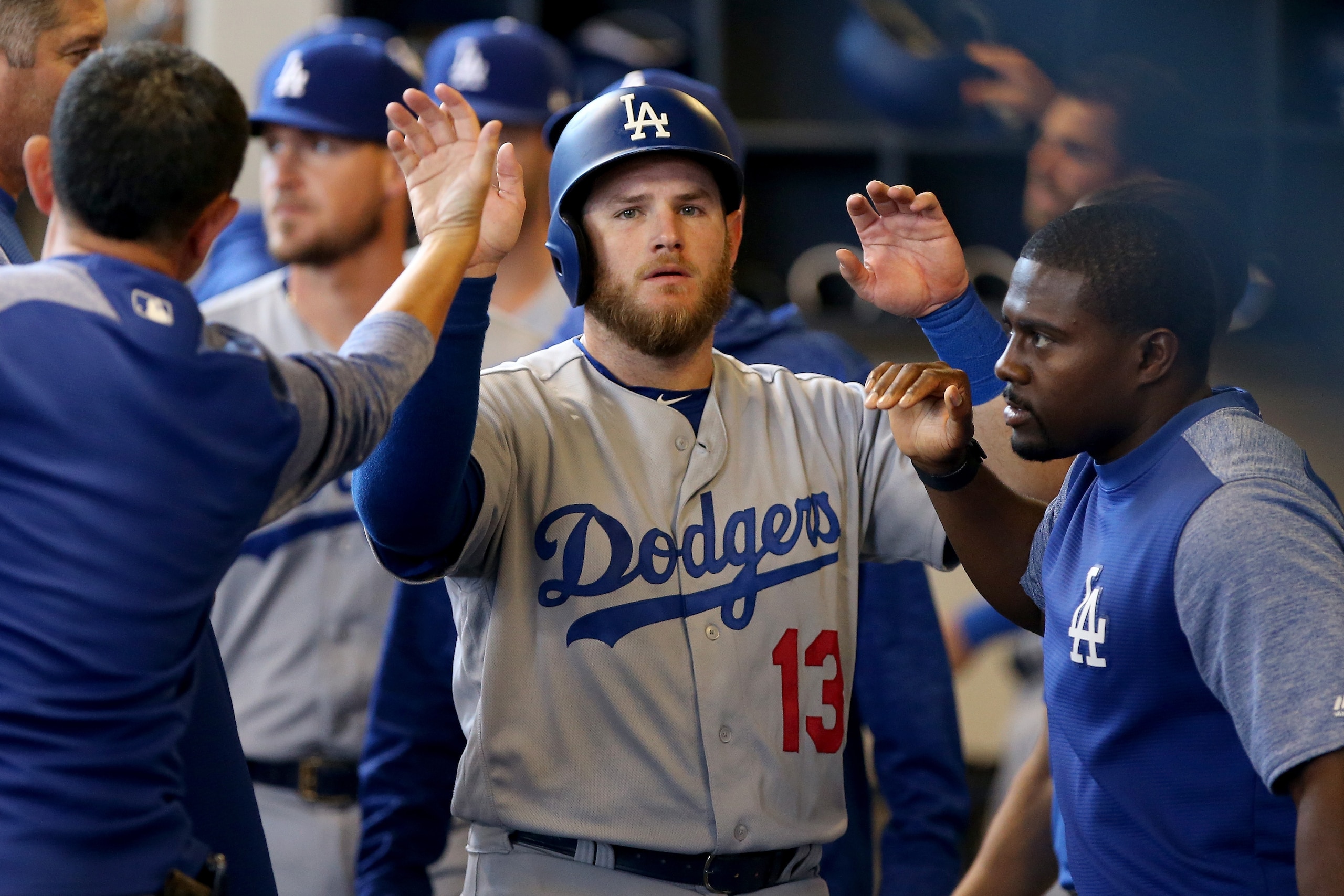 MILWAUKEE, WI - JULY 22: Max Muncy #13 of the Los Angeles Dodgers celebrates with teammates after scoring a run in the fifth inning against the Milwaukee Brewers at Miller Park on July 22, 2018 in Milwaukee, Wisconsin. (Photo by Dylan Buell/Getty Images) MILWAUKEE, WI - JULY 22: Max Muncy #13 of the Los Angeles Dodgers celebrates with teammates after scoring a run in the fifth inning against the Milwaukee Brewers at Miller Park on July 22, 2018 in Milwaukee, Wisconsin. (Photo by Dylan Buell/Getty Images)