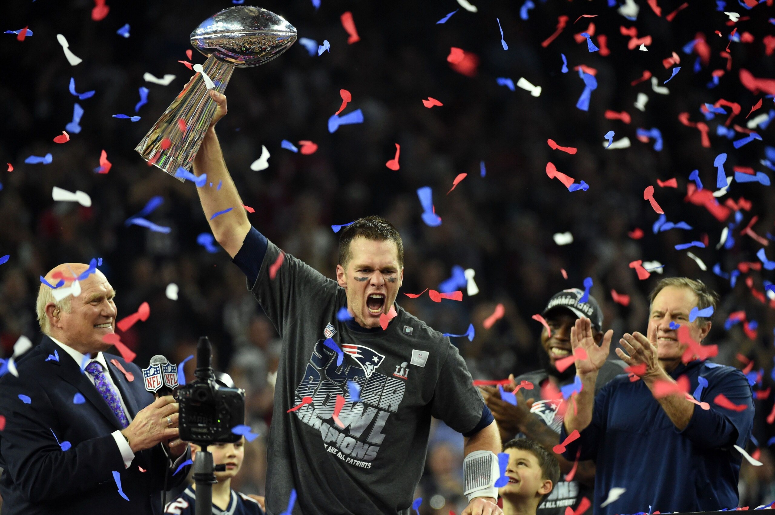 TOPSHOT - Tom Brady #12 of the New England Patriots holds the Vince Lombardi Trophy as Head coach Bill Belichick (R) looks on  after defeating the Atlanta Falcons 34-28 in overtime during Super Bowl 51 at NRG Stadium on February 5, 2017 in Houston, Texas.