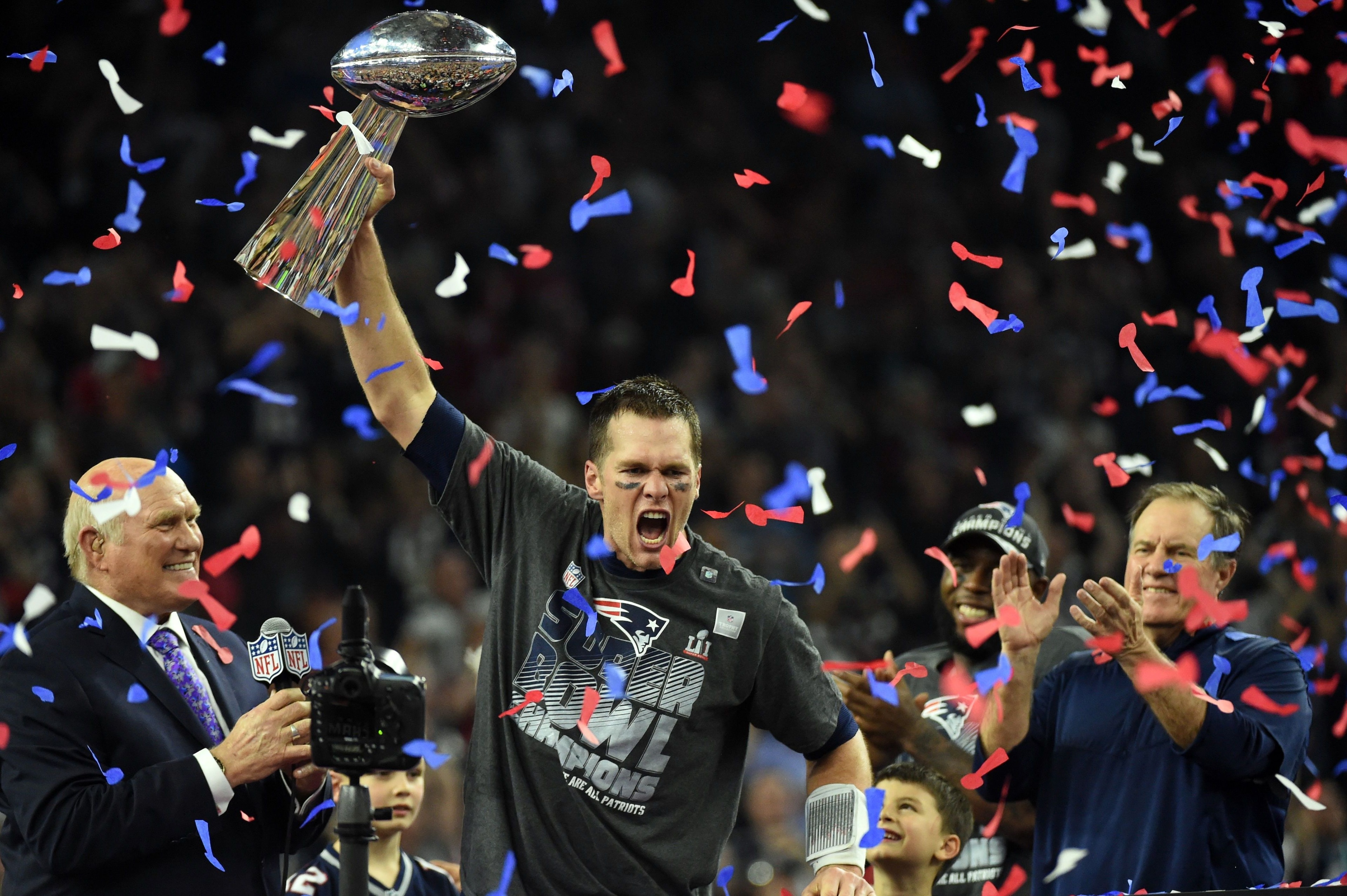 TOPSHOT - Tom Brady #12 of the New England Patriots holds the Vince Lombardi Trophy as Head coach Bill Belichick (R) looks on  after defeating the Atlanta Falcons 34-28 in overtime during Super Bowl 51 at NRG Stadium on February 5, 2017 in Houston, Texas.