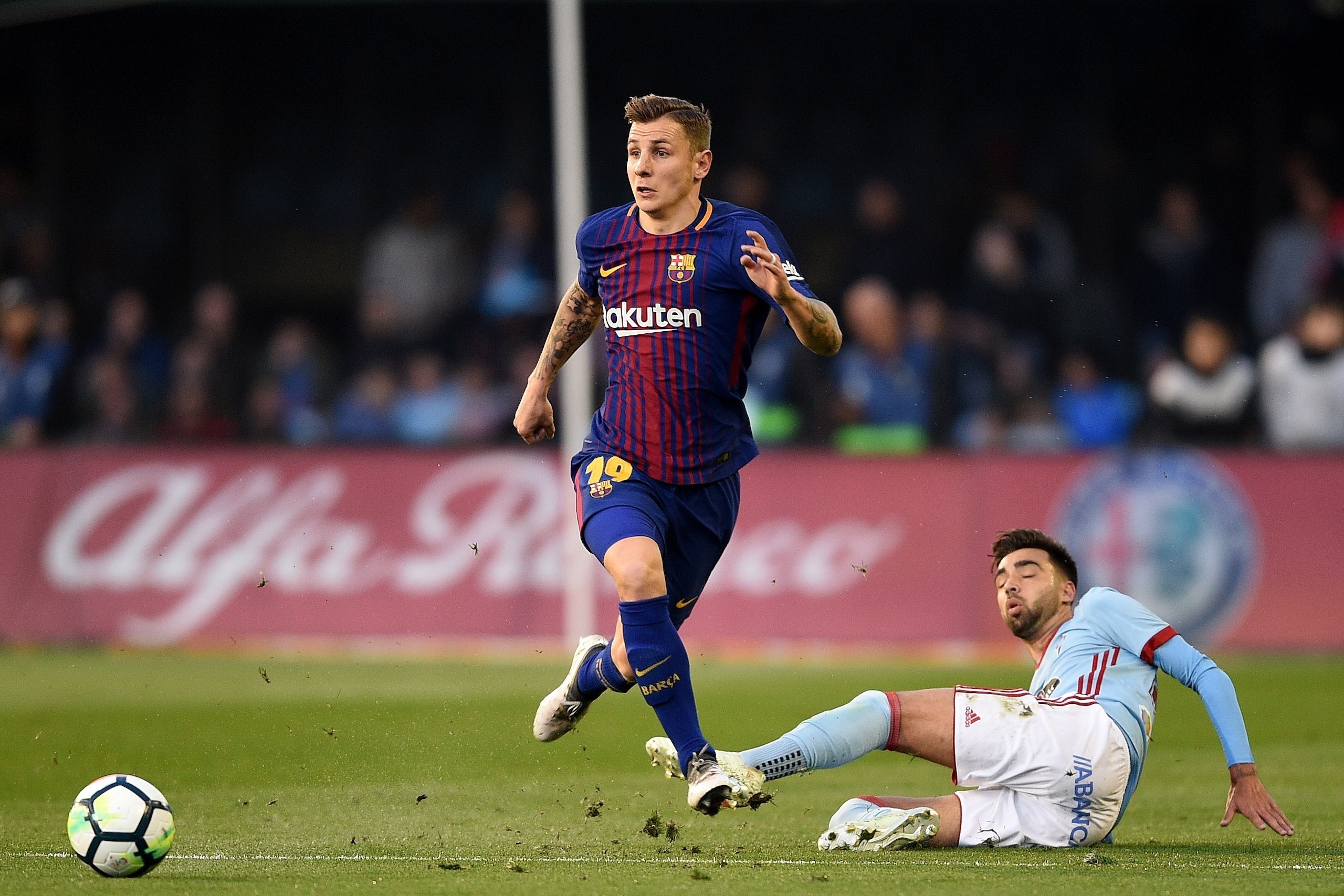 VIGO, SPAIN - APRIL 17: Brais Mendez of Celta de Vigo competes fo the ball with Lucas Digne of Barcelona during the La Liga match between Celta de Vigo and Barcelona at Municipal Balaidos on April 17, 2018 in Vigo,Spain . (Photo by Octavio Passos/Getty Im