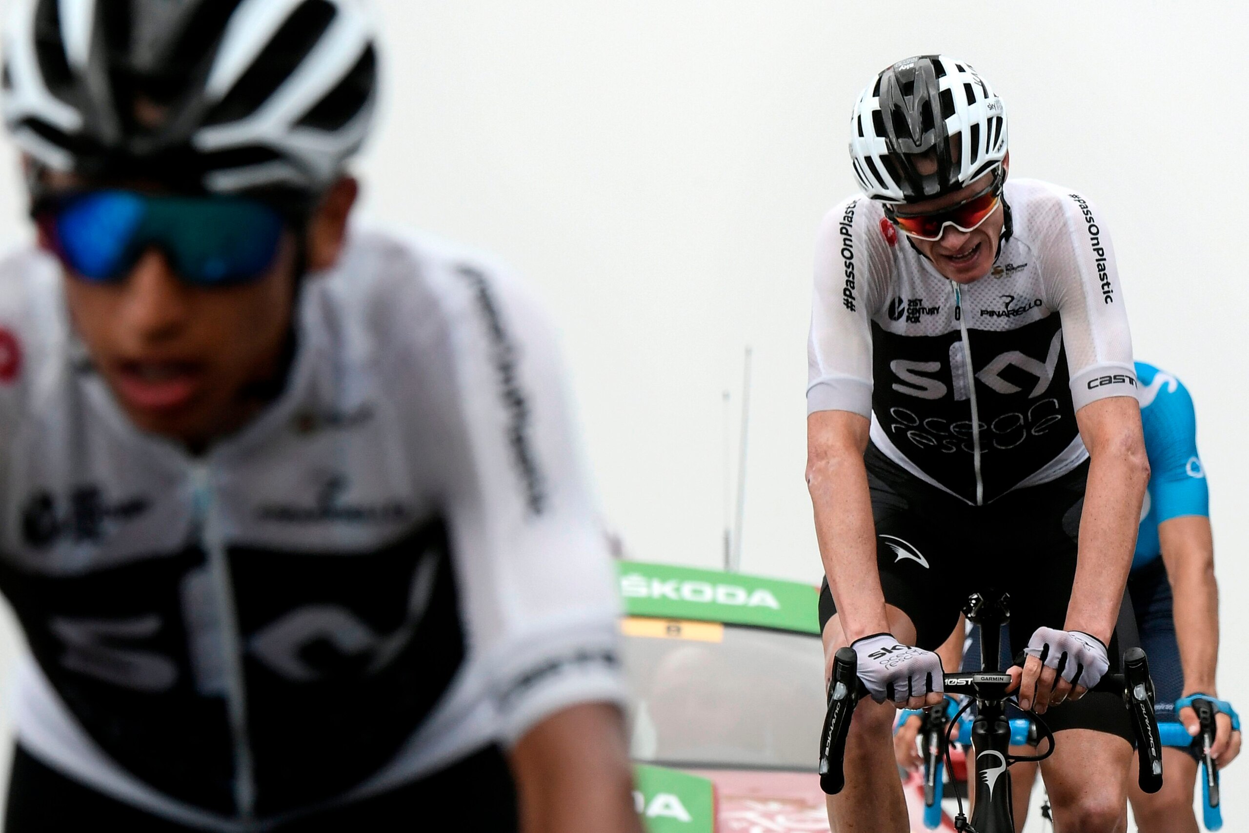 Great Britain's Christopher Froome (R) crosses the finish line to place 8th of the 17th stage of the 105th edition of the Tour de France cycling race, between Bagneres-de-Luchon and Saint-Lary-Soulan Col du Portet, southwestern France, on July 25, 2018. (