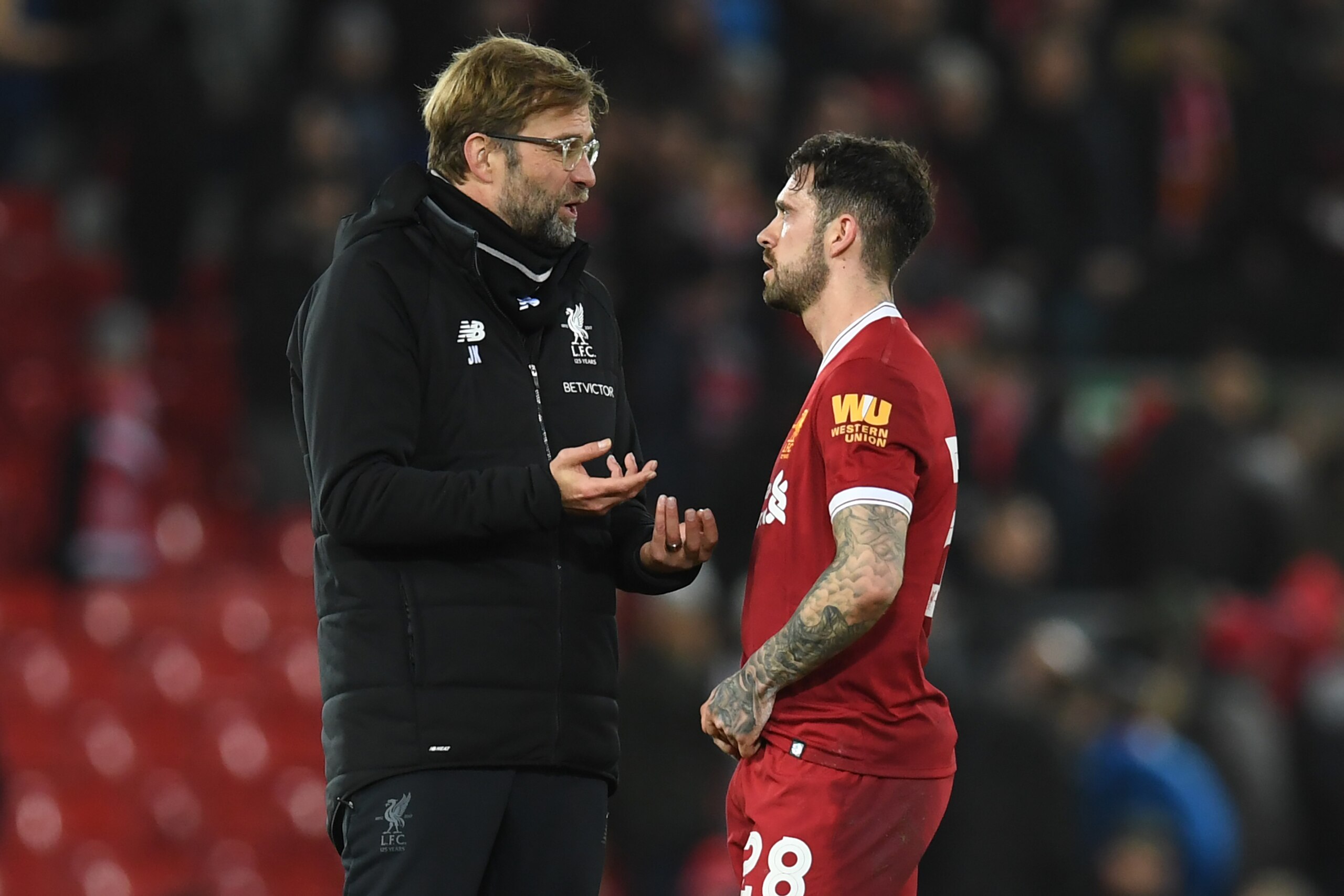 Liverpool's German manager Jurgen Klopp (L) speaks with Liverpool's English striker Danny Ings after the English FA Cup fourth round football match between Liverpool and West Bromwich Albion at Anfield in Liverpool, north west England on January 27, 2018.