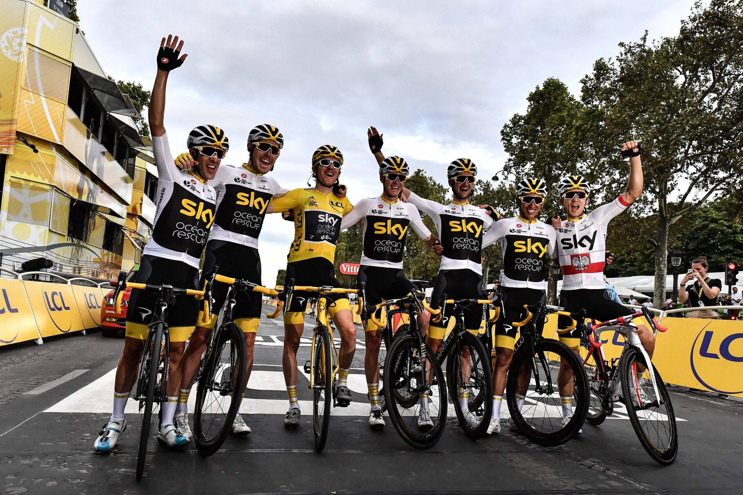 (L-R) Sky team members Spain's Jonathan Castroviejo, Great Britain's Luke Rowe, Tour de France winner Great Britain's Geraint Thomas wearing the overall leader's yellow jersey, Tour de France third-placed Great Britain's Christopher Froome, Netherlands' W