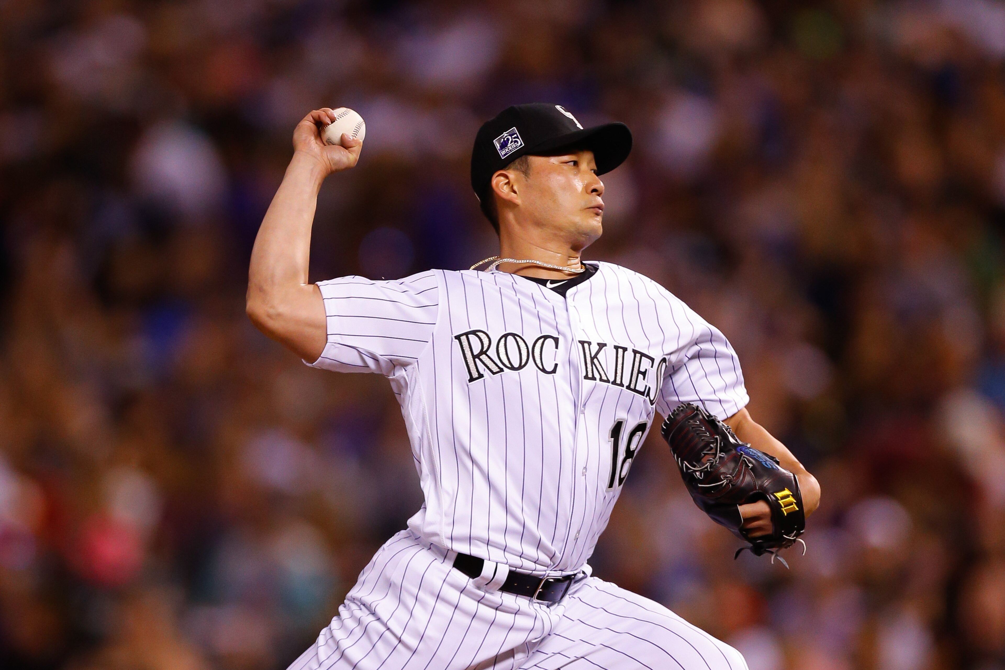 DENVER, CO - JULY 28:  Seunghwan Oh #18 of the Colorado Rockies delivers to home plate against the Oakland Athletics during the seventh inning of interleague play at Coors Field on July 28, 2018 in Denver, Colorado. (Photo by Justin Edmonds/Getty Images)
