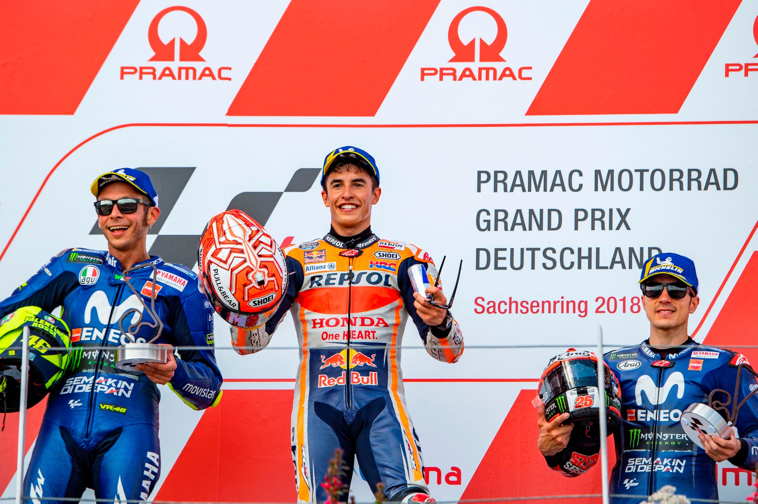 (L-R) Second placed Italian Yamaha rider Valentino Rossi, winner Spanish Honda rider Marc Marquez and third placed Spanish Yamaha rider Maverick Vinales stand on the podium after the Moto GP race at the Grand Prix of Germany at the Sachsenring Circuit on 