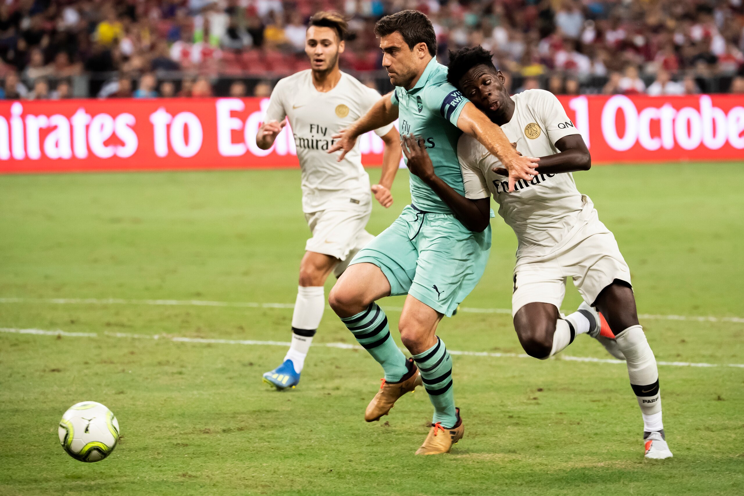 SINGAPORE,SINGAPORE - July 28: Timothy Weah of Paris Saint Germain fights for the ball with Sokratis Papastathopoulos of Arsenal during the International Champions Cup 2018 match between Arsenal and Paris Saint Germain (Photo by PictoBank/Getty Images) SINGAPORE,SINGAPORE - July 28: Timothy Weah of Paris Saint Germain fights for the ball with Sokratis Papastathopoulos of Arsenal during the International Champions Cup 2018 match between Arsenal and Paris Saint Germain (Photo by PictoBank/Getty Images)