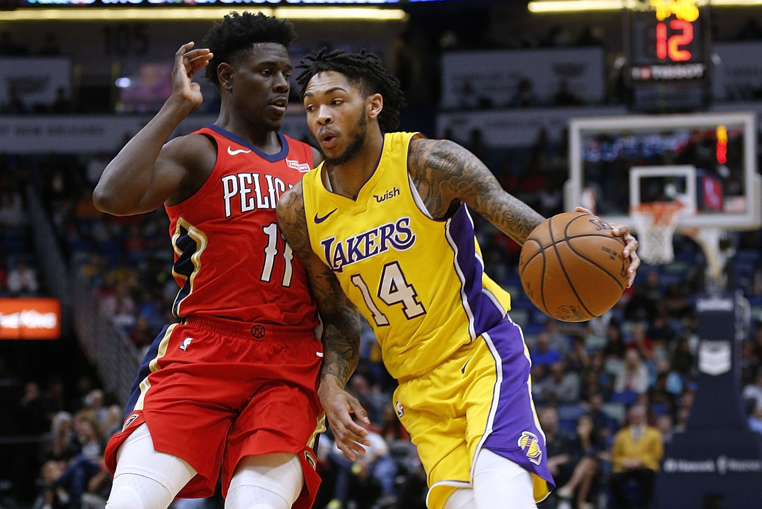 NEW ORLEANS, LA - FEBRUARY 14: Brandon Ingram #14 of the Los Angeles Lakers drives against Jrue Holiday #11 of the New Orleans Pelicans during the first half at Smoothie King Center on February 14, 2018 in New Orleans, Louisiana. NOTE TO USER: User expre NEW ORLEANS, LA - FEBRUARY 14: Brandon Ingram #14 of the Los Angeles Lakers drives against Jrue Holiday #11 of the New Orleans Pelicans during the first half at Smoothie King Center on February 14, 2018 in New Orleans, Louisiana. NOTE TO USER: User expre