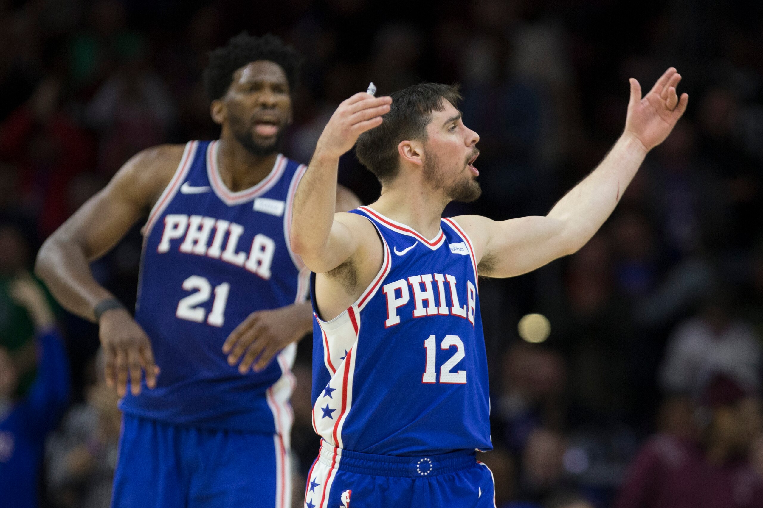 PHILADELPHIA, PA - JANUARY 15: Joel Embiid #21 and T.J. McConnell #12 of the Philadelphia 76ers react in the fourth quarter against the Toronto Raptors at the Wells Fargo Center on January 15, 2018 in Philadelphia, Pennsylvania. The 76ers defeated the Rap