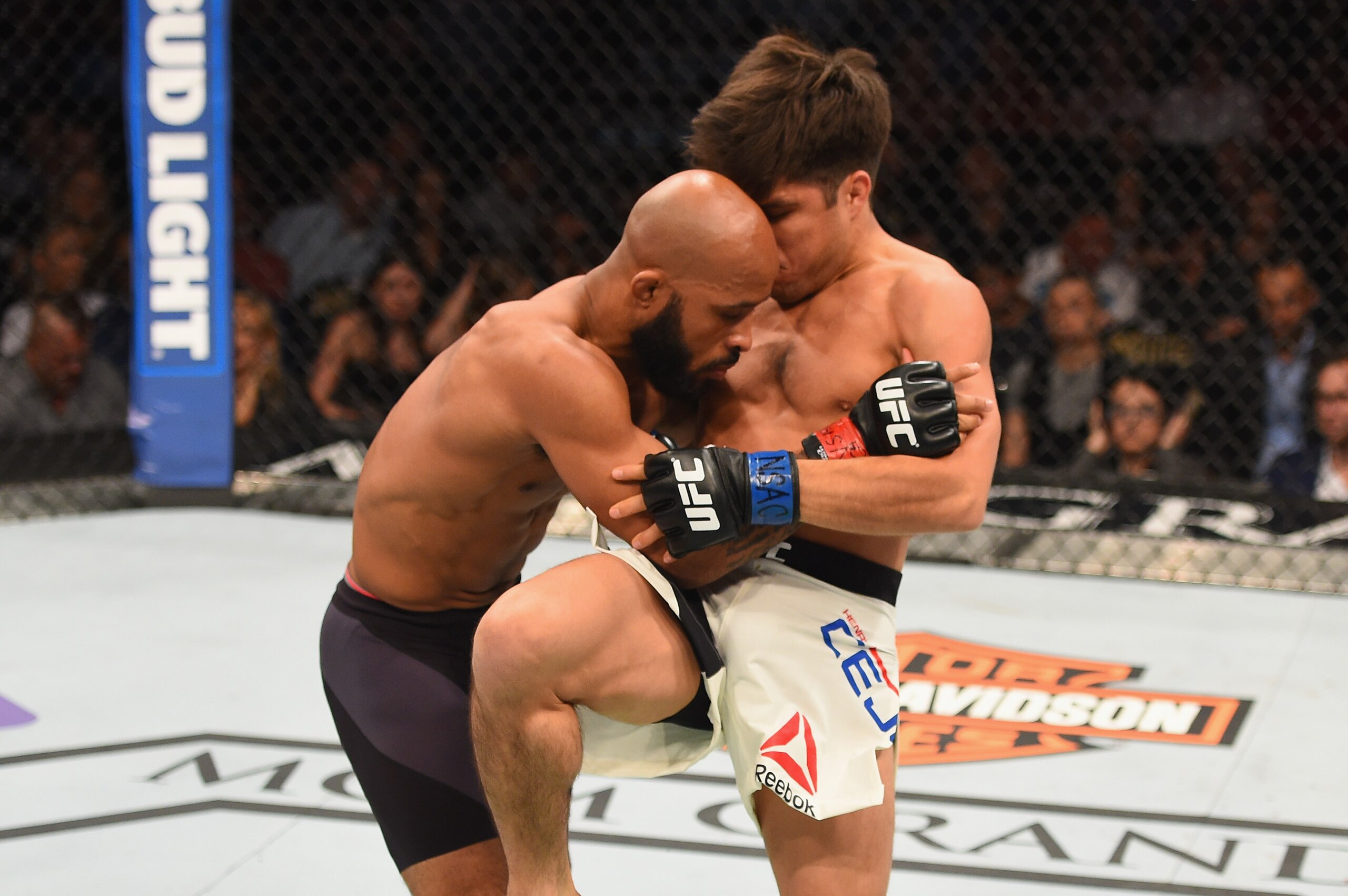 LAS VEGAS, NV - APRIL 23: (R-L) Henry Cejudo knees Demetrious Johnson in their flyweight championship bout during the UFC 197 event inside MGM Grand Garden Arena on April 23, 2016 in Las Vegas, Nevada. (Photo by Josh Hedges/Zuffa LLC/Zuffa LLC via Getty LAS VEGAS, NV - APRIL 23: (R-L) Henry Cejudo knees Demetrious Johnson in their flyweight championship bout during the UFC 197 event inside MGM Grand Garden Arena on April 23, 2016 in Las Vegas, Nevada. (Photo by Josh Hedges/Zuffa LLC/Zuffa LLC via Getty