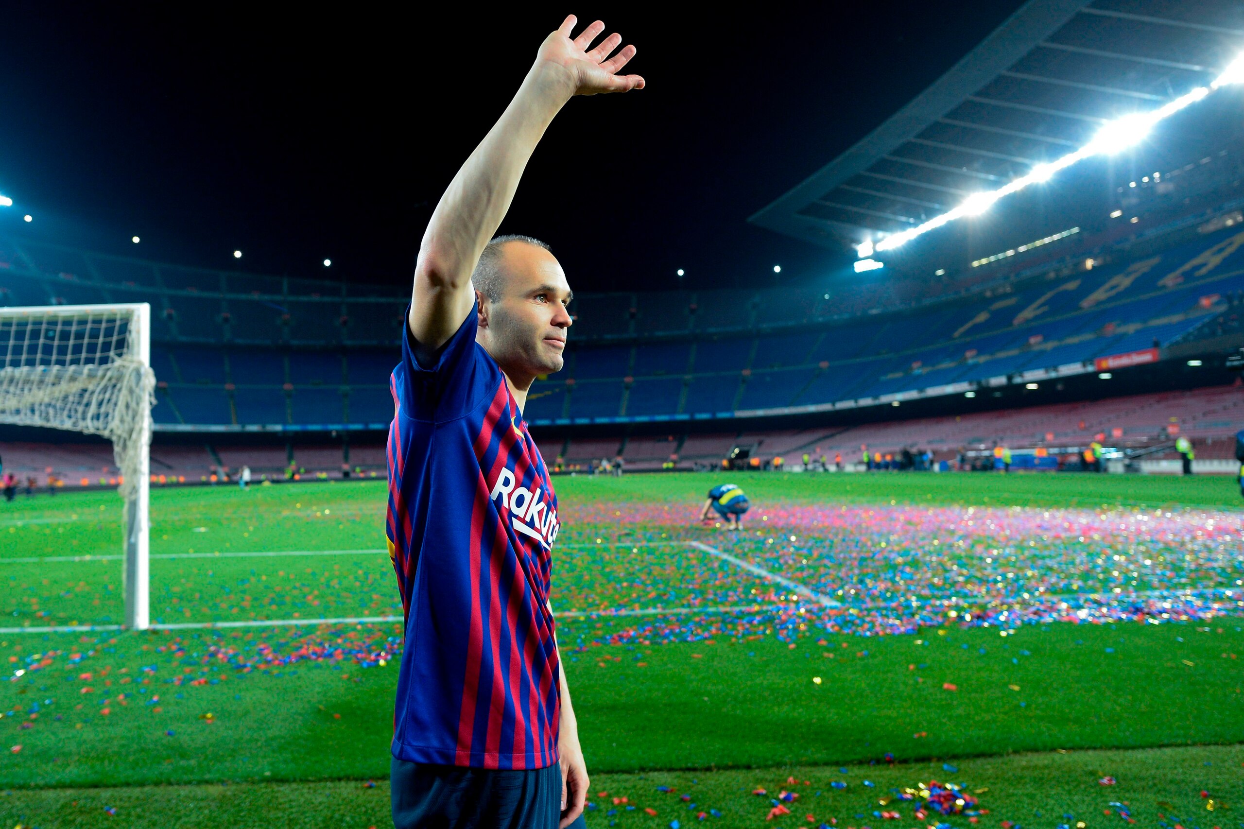 TOPSHOT - Barcelona's Spanish midfielder Andres Iniesta waves at the end of a tribute after the Spanish league football match between FC Barcelona and Real Sociedad at the Camp Nou stadium in Barcelona on May 20, 2018. - Iniesta, who joined Barcelona's ac