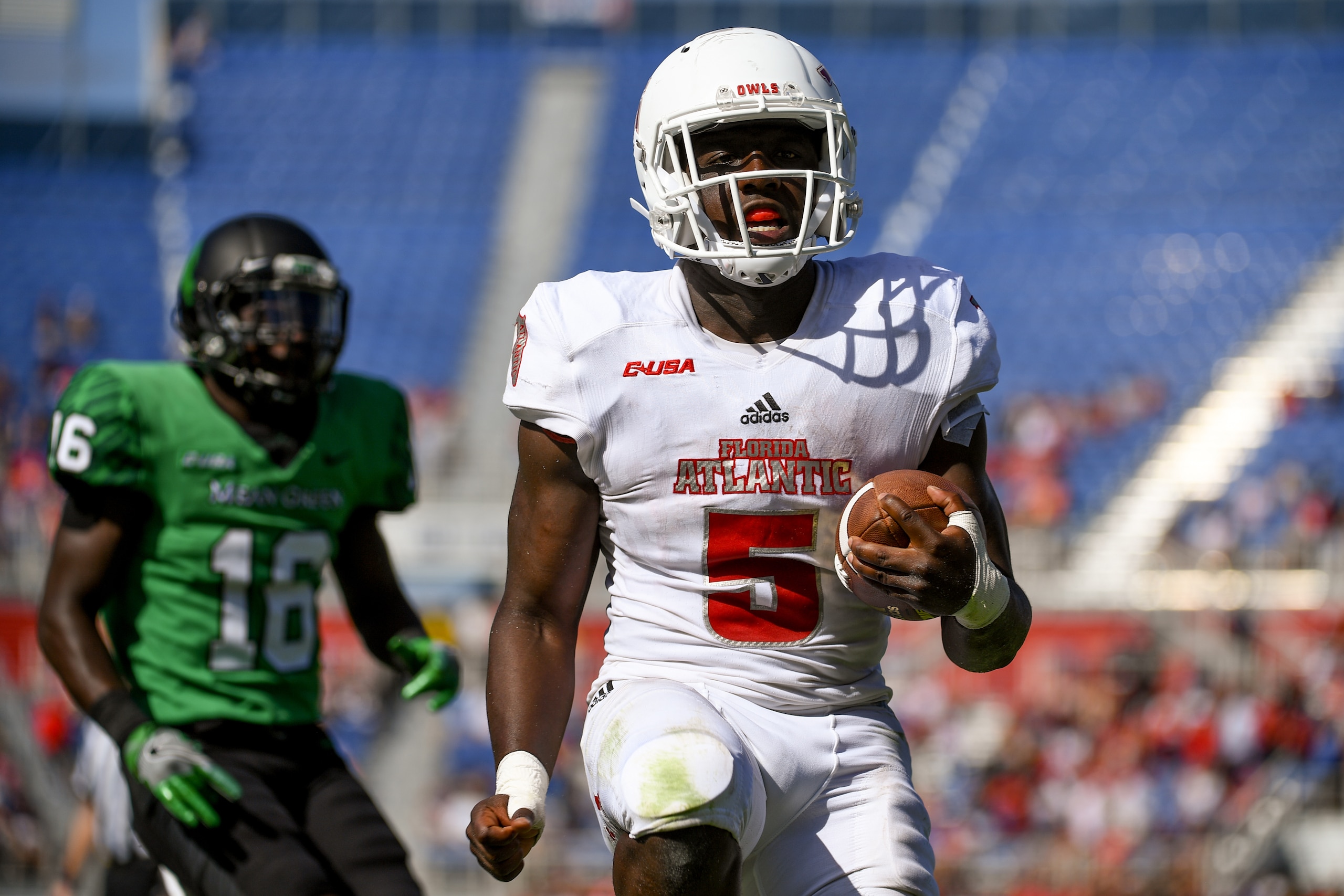 BOCA RATON, FL - DECEMBER 02: Devin Singletary #5 of the Florida Atlantic Owls rushes for a touchdown past Kemon Hall #16 of the North Texas Mean Green during the Conference USA Championship game at FAU Stadium on December 2, 2017 in Boca Raton, Florida. 