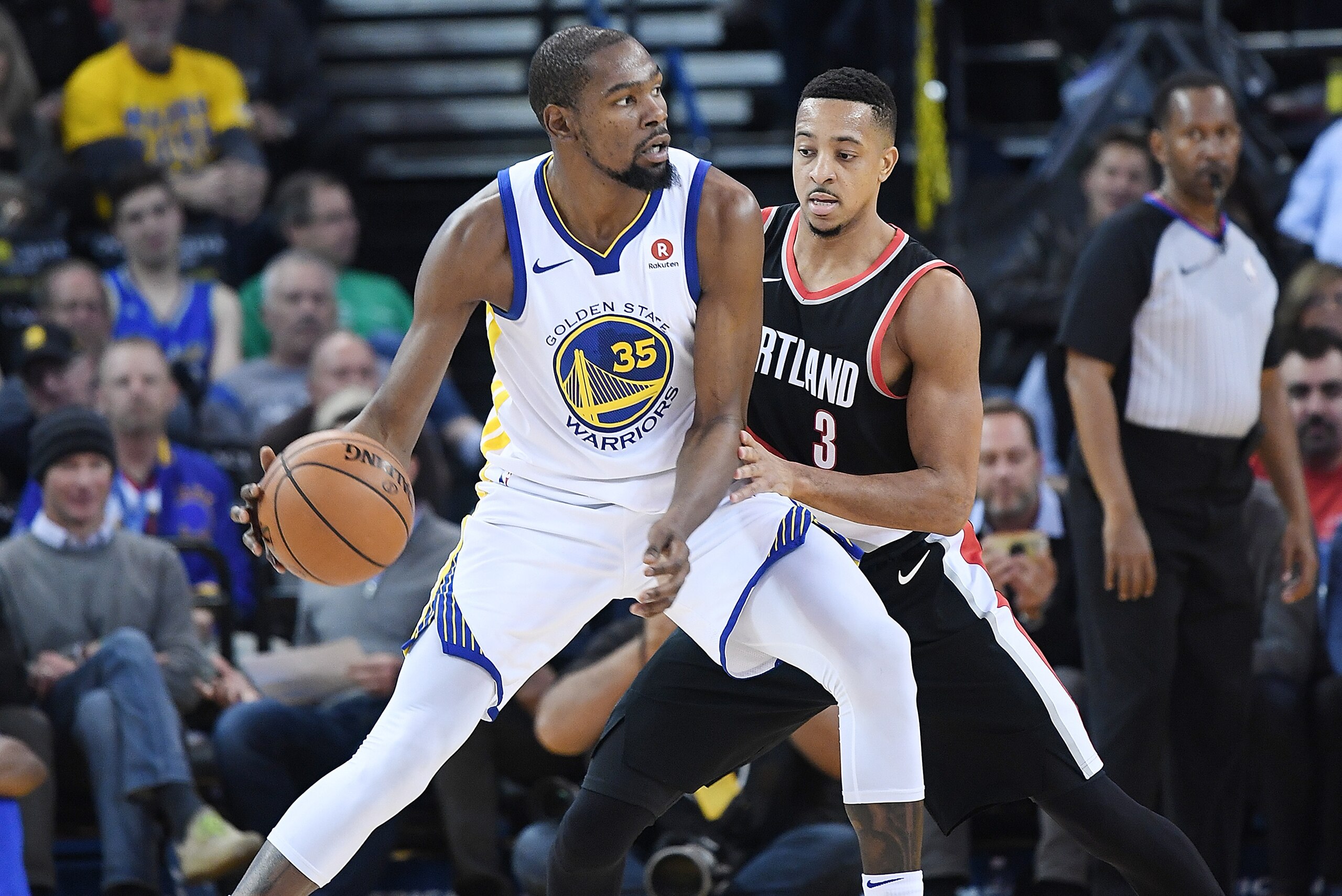 OAKLAND, CA - DECEMBER 11: Kevin Durant #35 of the Golden State Warriors dribbling the ball backs in on CJ McCollum #3 of the Portland Trail Blazers during an NBA basketball game at ORACLE Arena on December 11, 2017 in Oakland, California. NOTE TO USER: OAKLAND, CA - DECEMBER 11: Kevin Durant #35 of the Golden State Warriors dribbling the ball backs in on CJ McCollum #3 of the Portland Trail Blazers during an NBA basketball game at ORACLE Arena on December 11, 2017 in Oakland, California. NOTE TO USER: