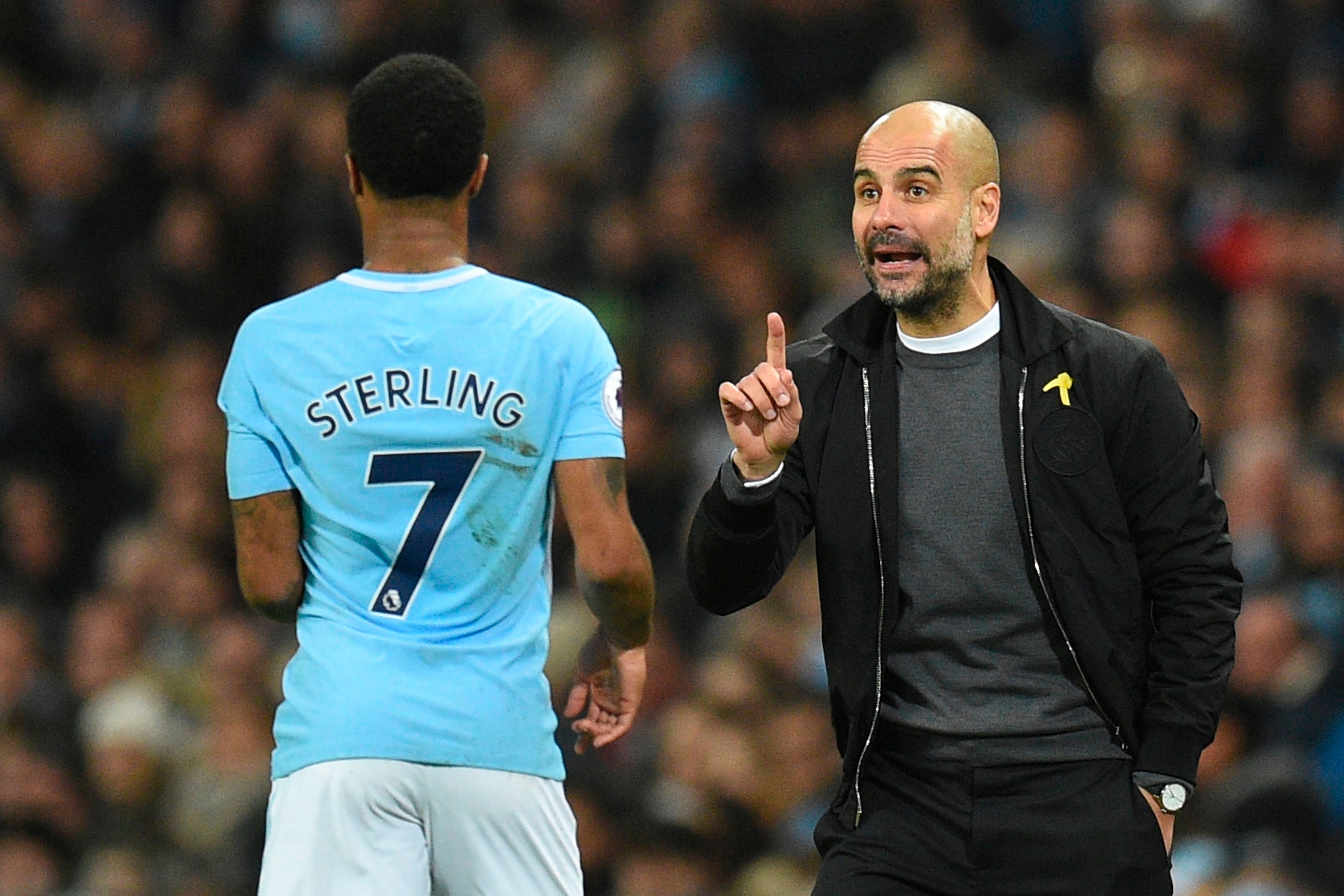 Manchester City's Spanish manager Pep Guardiola (R) gestures on the touchline to Manchester City's English midfielder Raheem Sterling (L) during the English Premier League football match between Manchester City and Bournemouth at the Etihad Stadium in Man