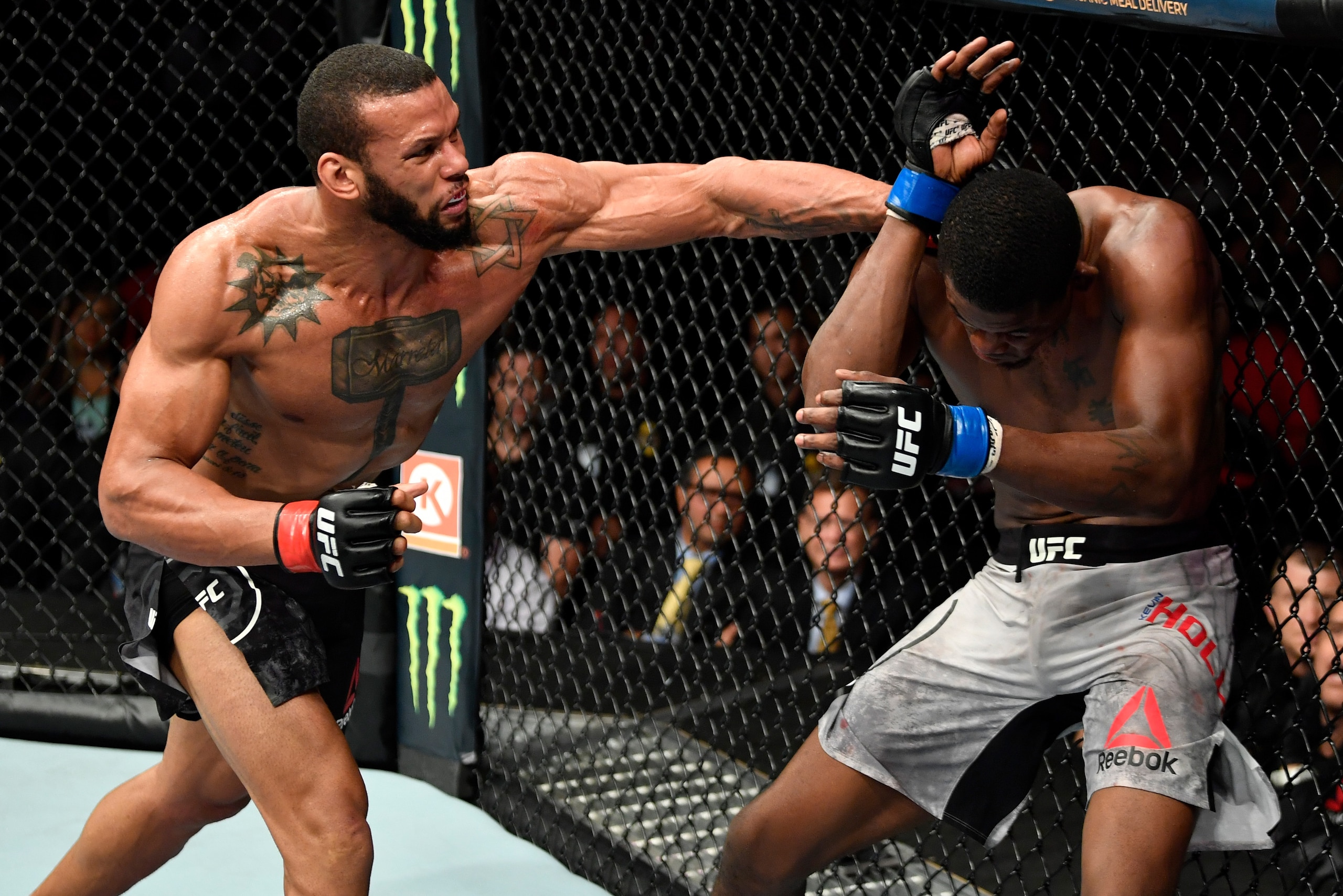 LOS ANGELES, CA - AUGUST 04: (L-R) Thiago Santos of Brazil punches Kevin Holland in their middleweight fight during the UFC 227 event inside Staples Center on August 4, 2018 in Los Angeles, California. (Photo by Jeff Bottari/Zuffa LLC/Zuffa LLC via Getty LOS ANGELES, CA - AUGUST 04: (L-R) Thiago Santos of Brazil punches Kevin Holland in their middleweight fight during the UFC 227 event inside Staples Center on August 4, 2018 in Los Angeles, California. (Photo by Jeff Bottari/Zuffa LLC/Zuffa LLC via Getty